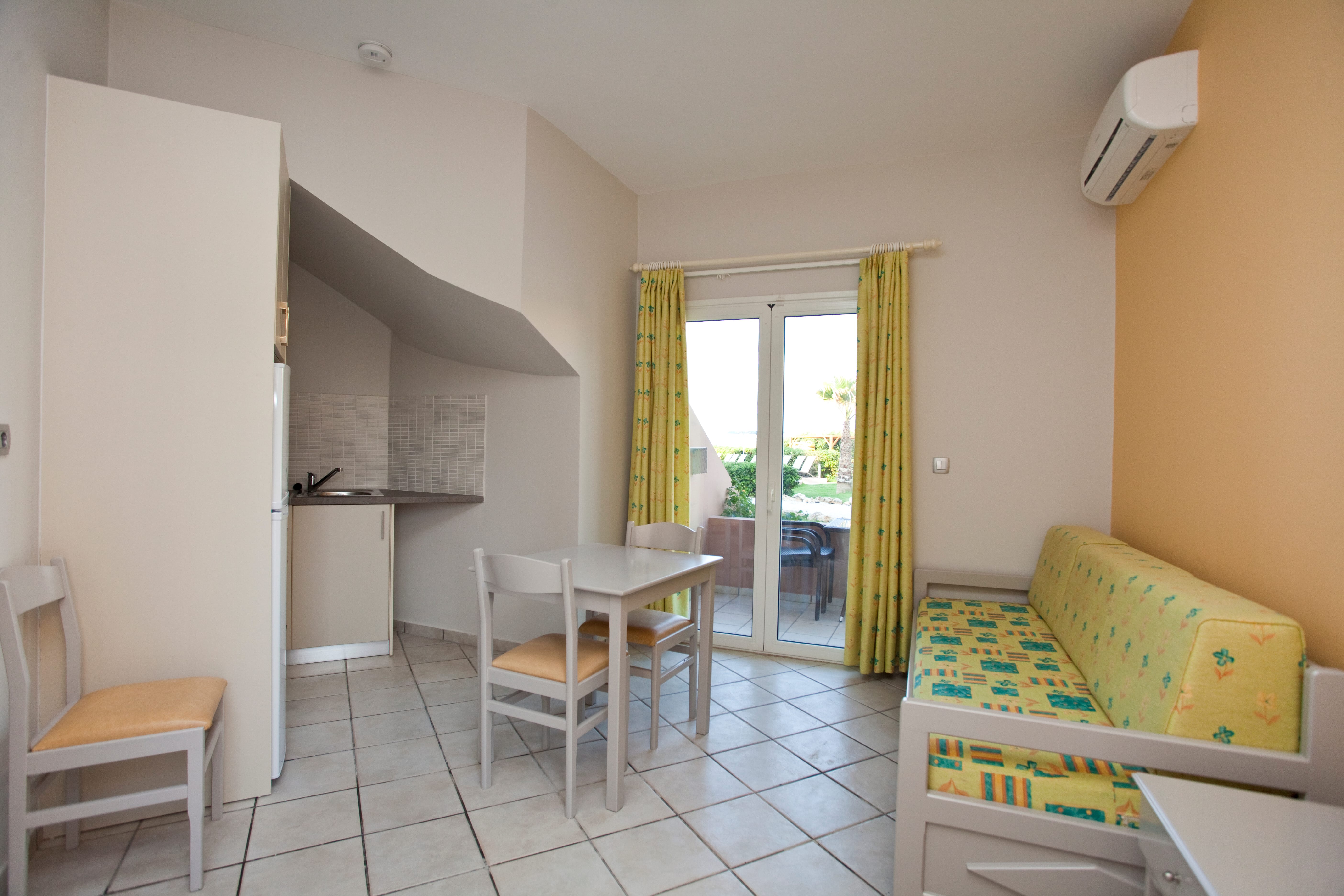 a room with a couch and chairs