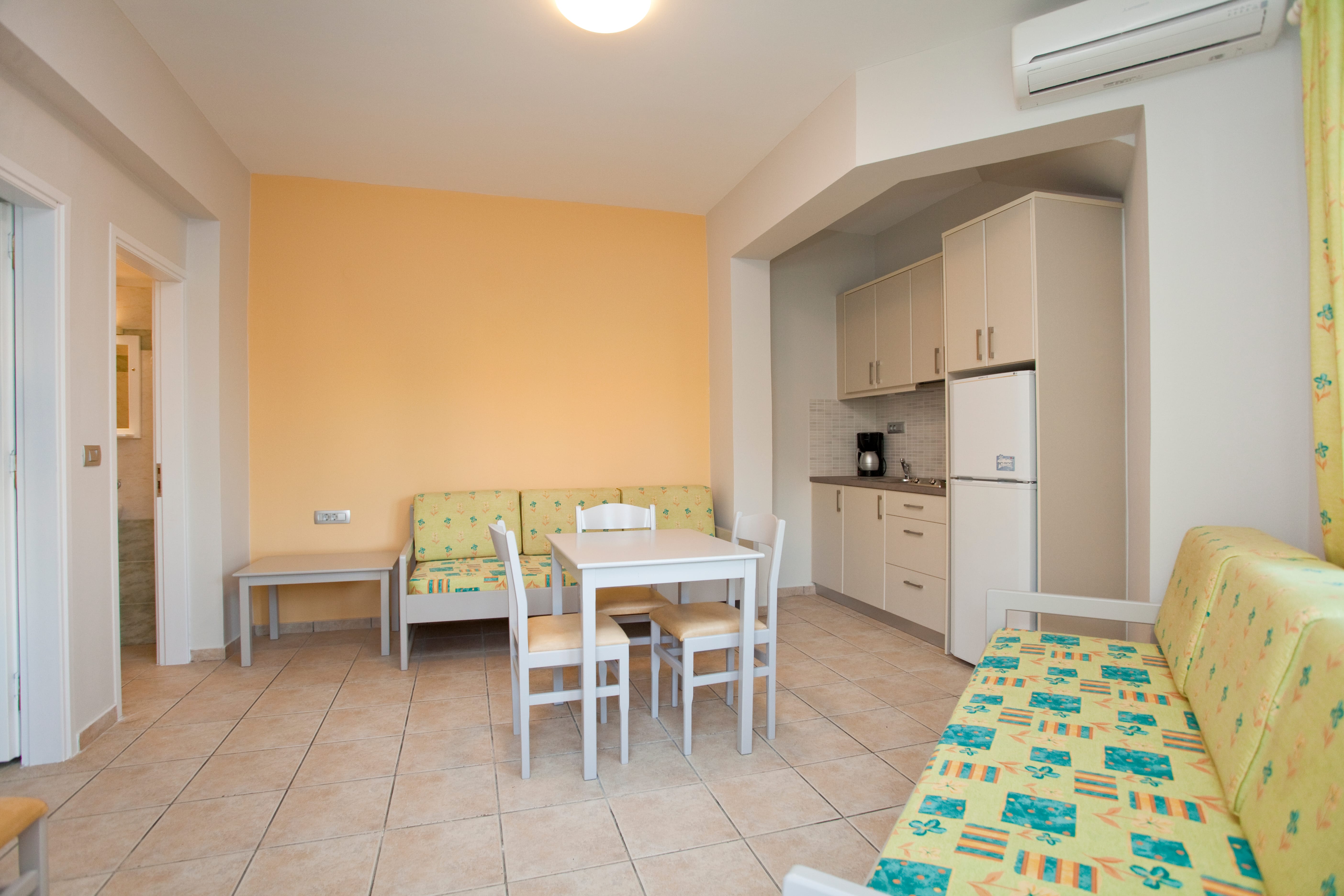 a room with a table chairs and a couch