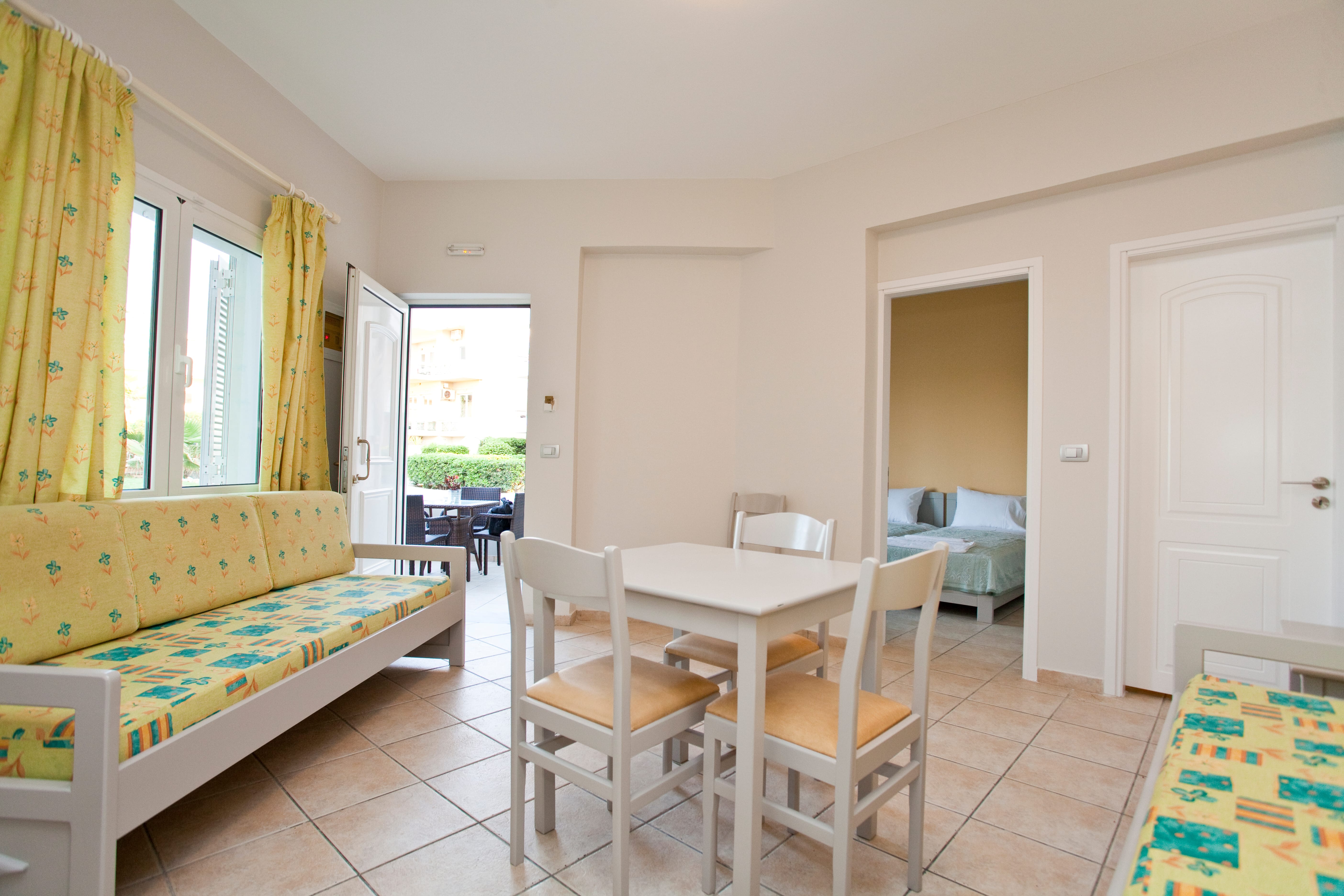 a room with a bed and chairs