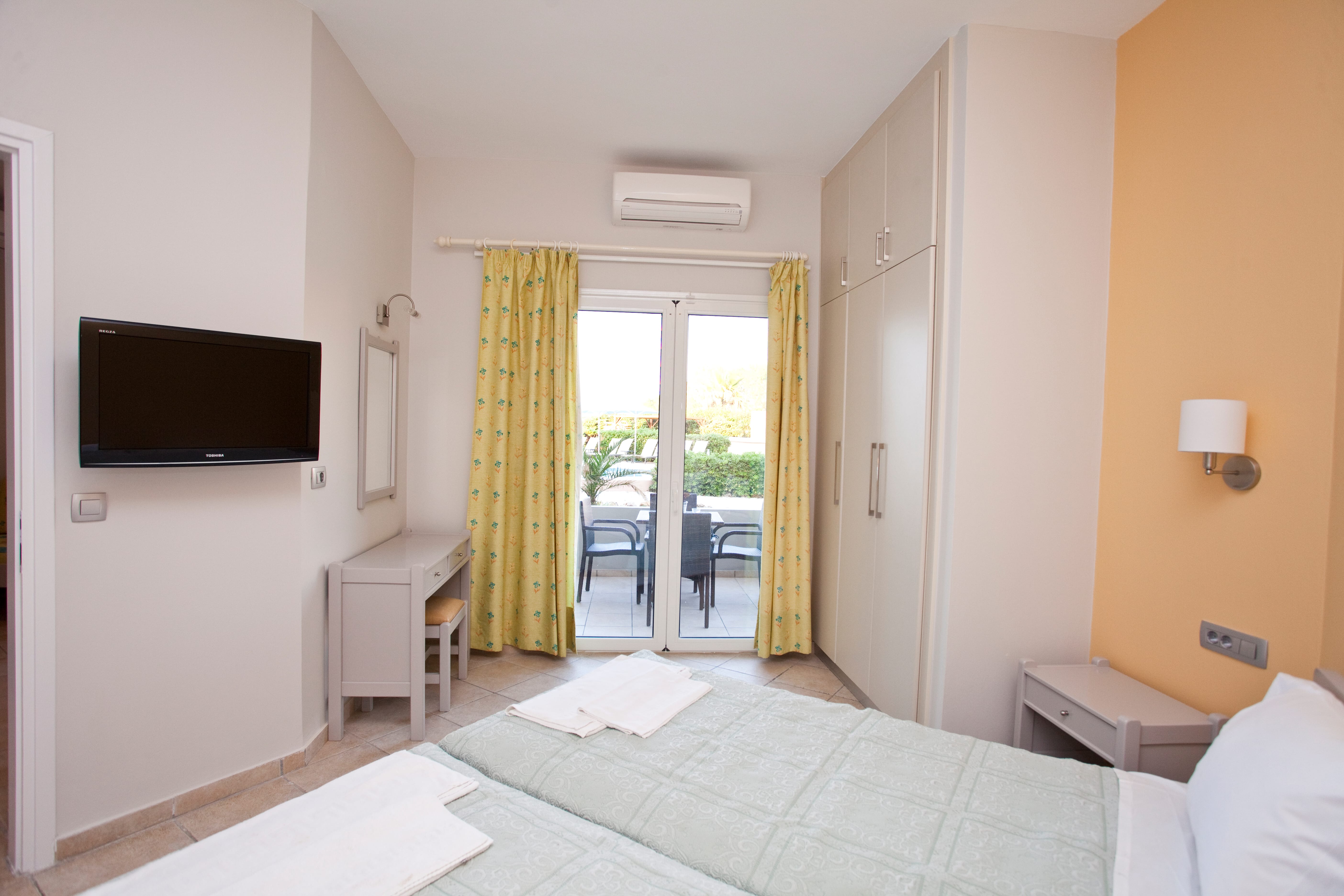 a bedroom with a tv and a bed