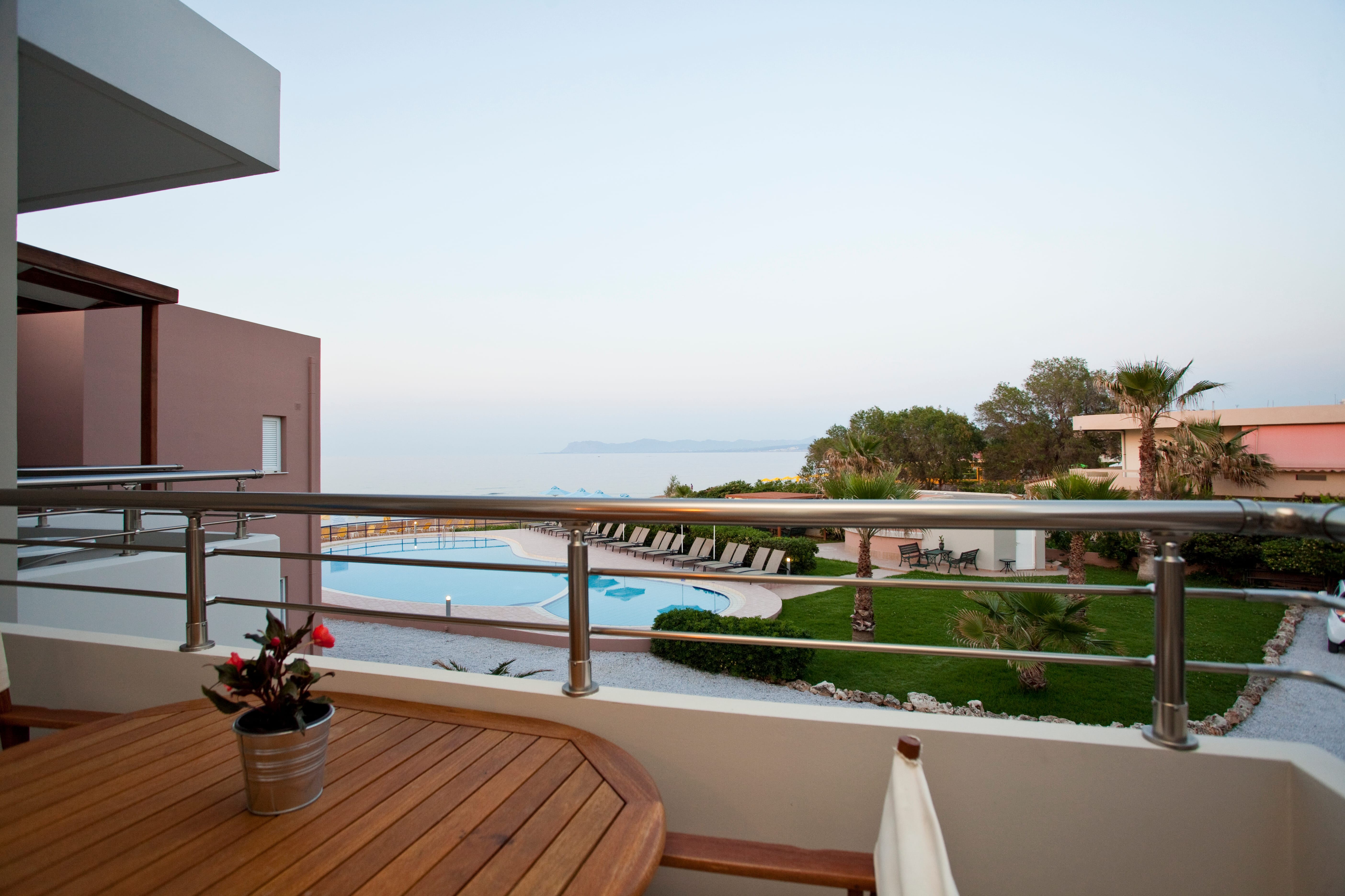a deck with a pool and a deck with a flower pot