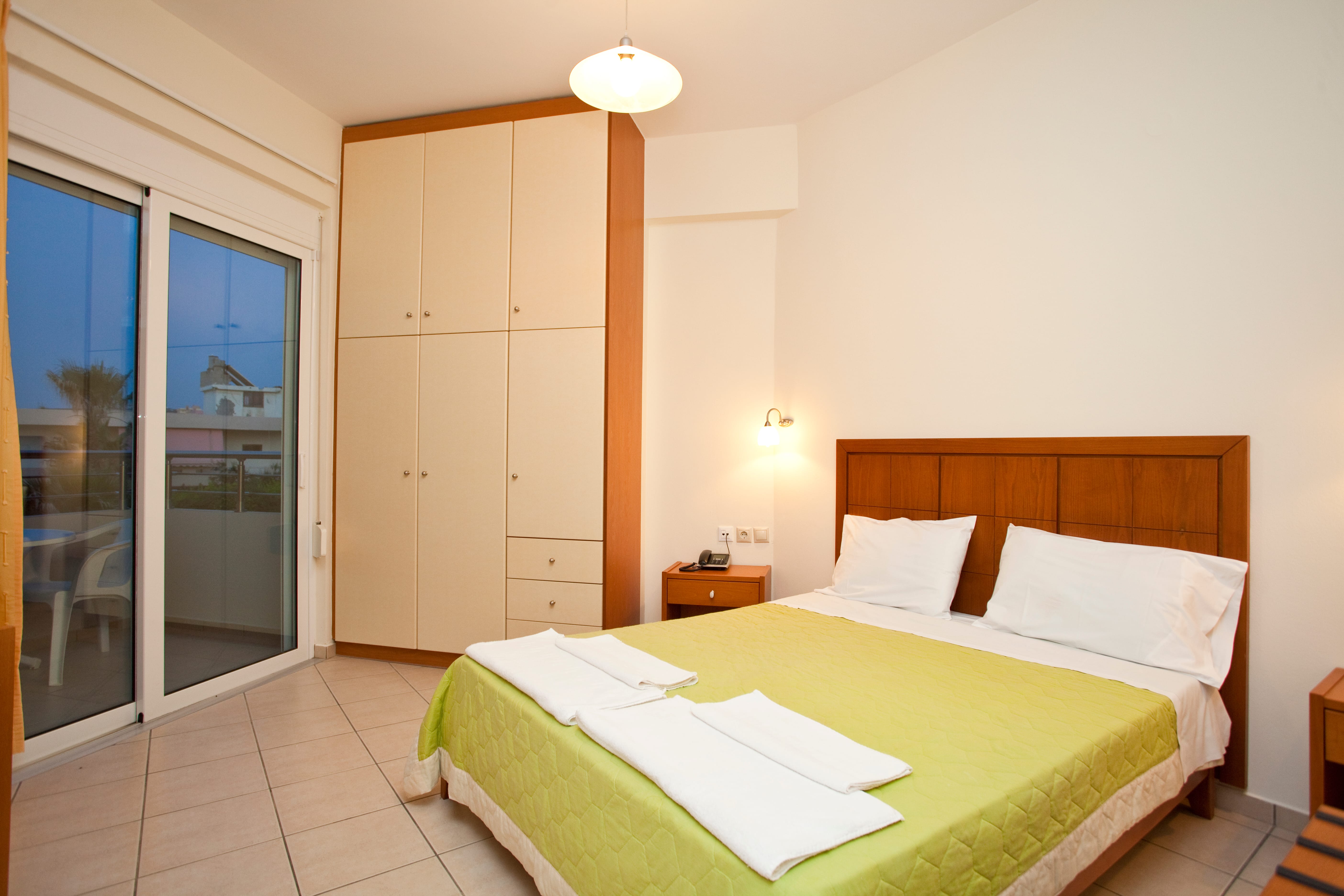 a bedroom with a bed and a glass door