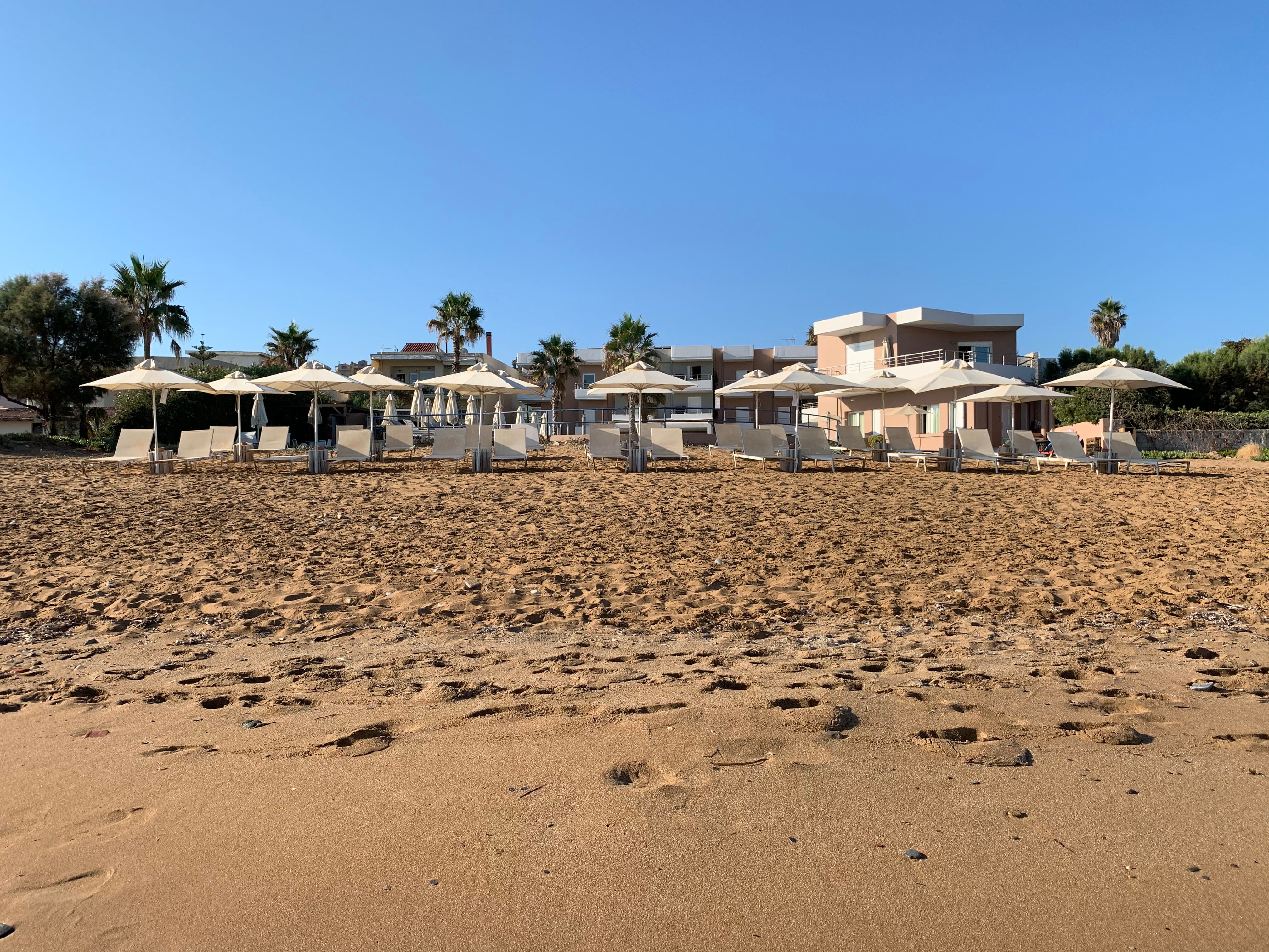 a sandy beach with umbrellas