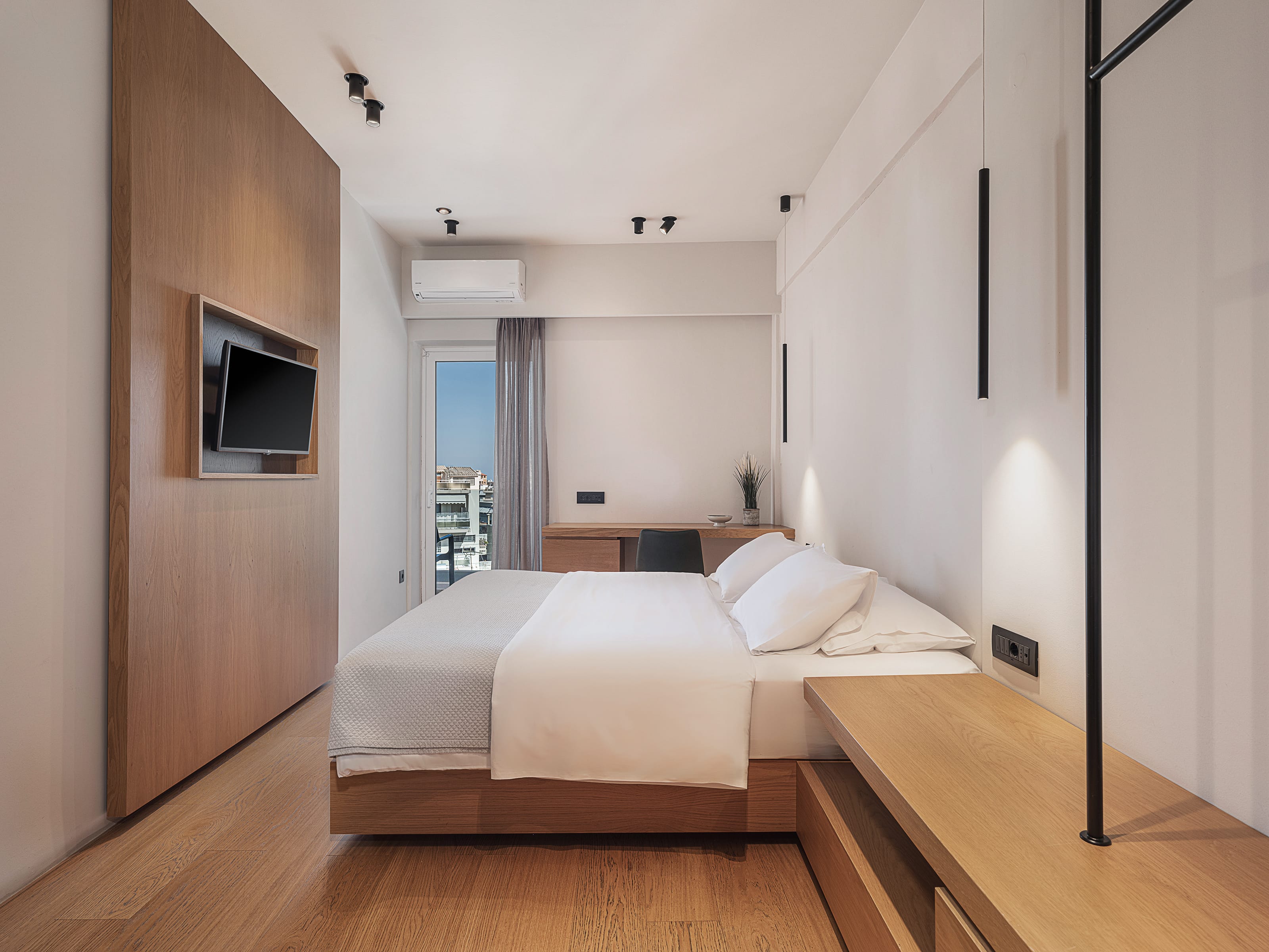 a bedroom with a bed and a tv