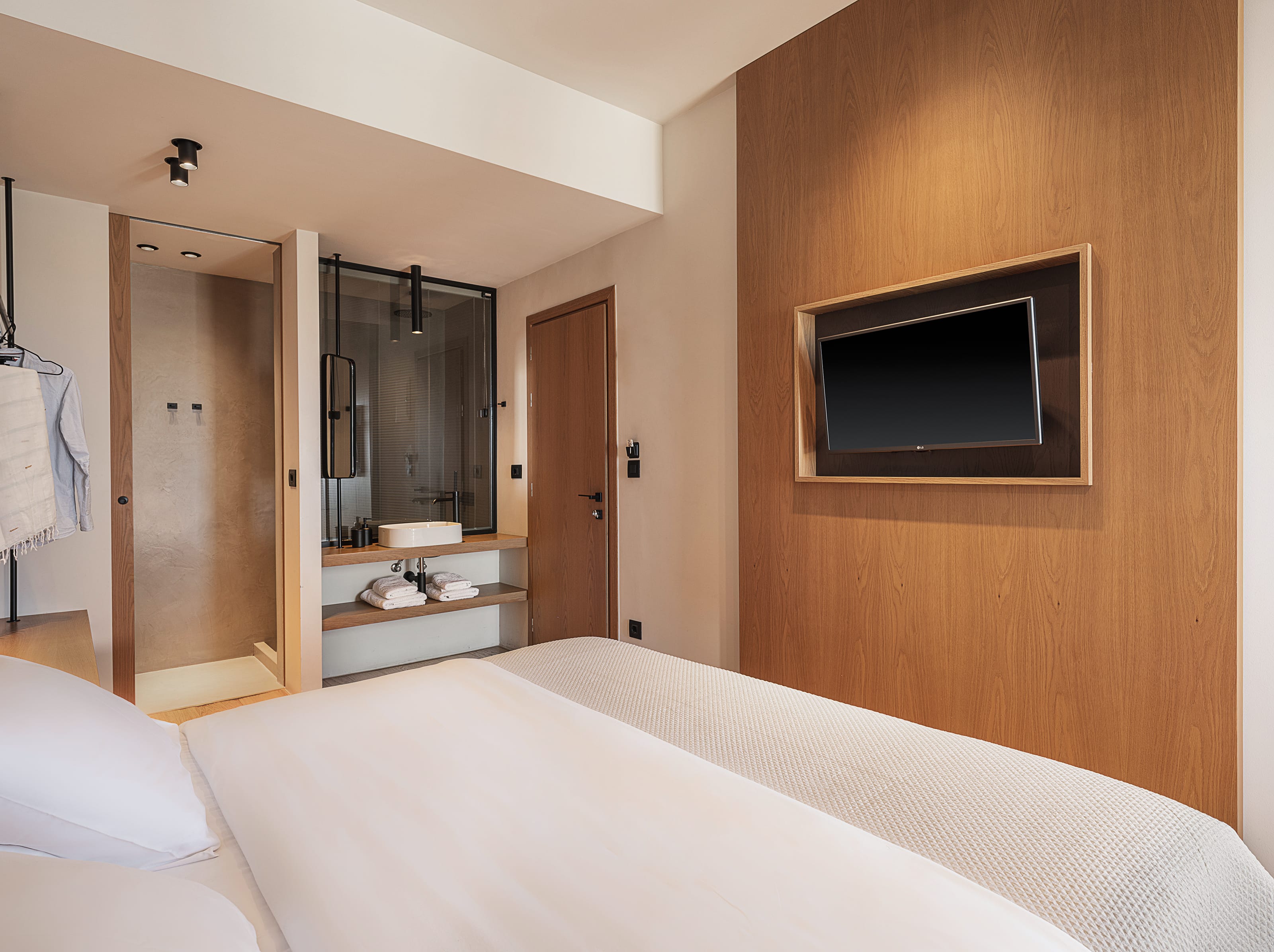 a bedroom with a tv and a bed