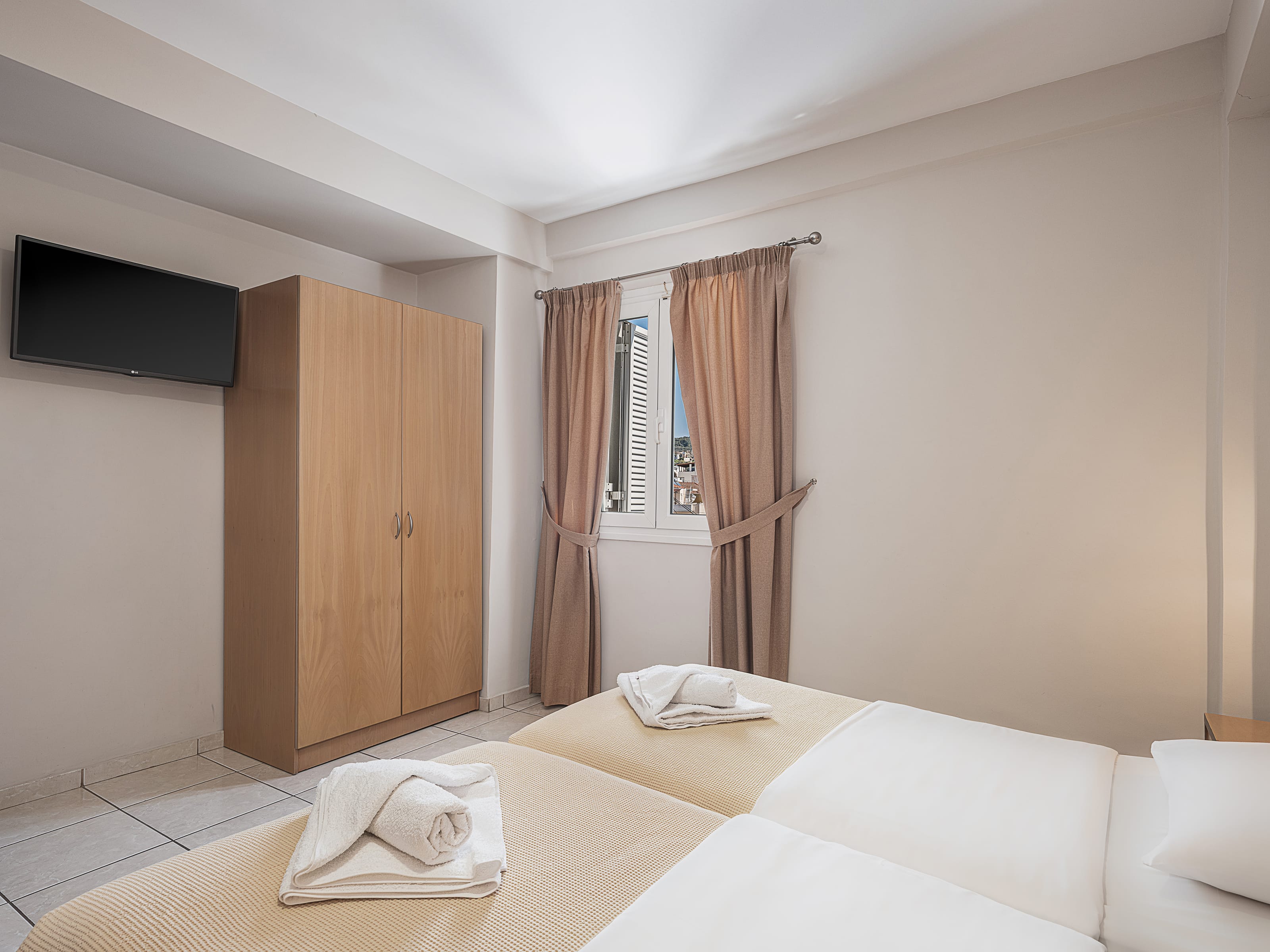 a hotel room with a bed and a television