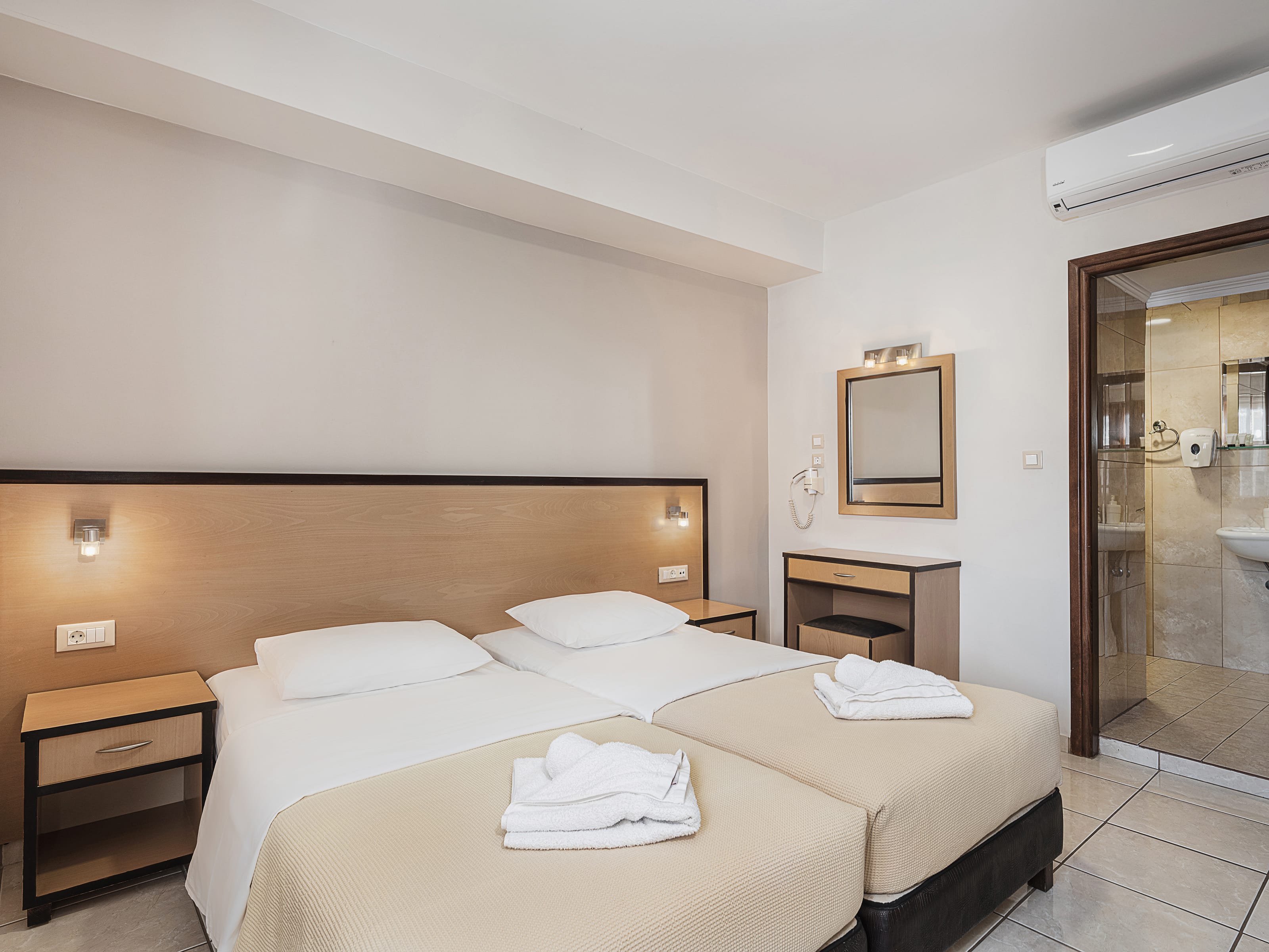 a hotel room with a bed and a mirror