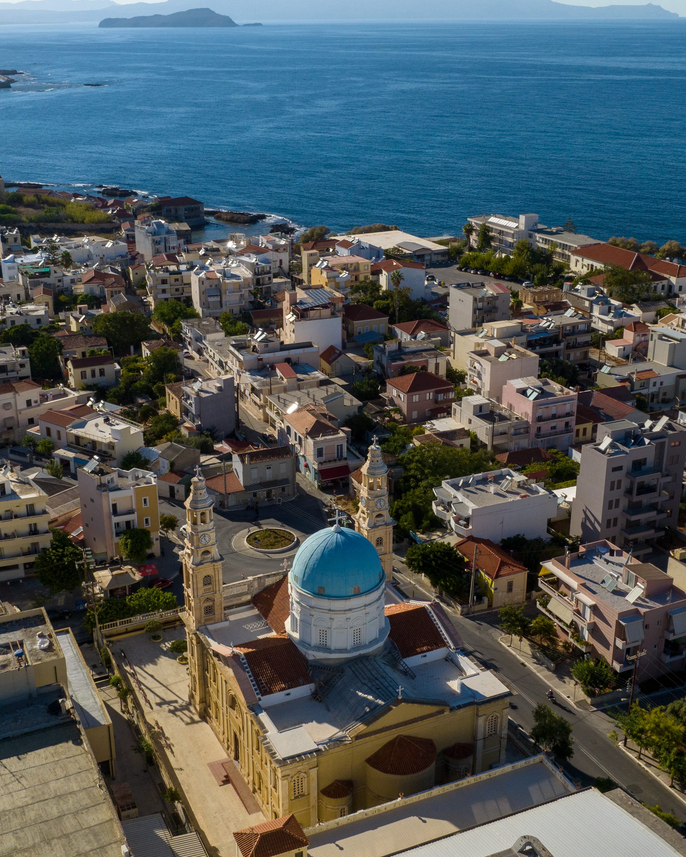 a city with a body of water in the background