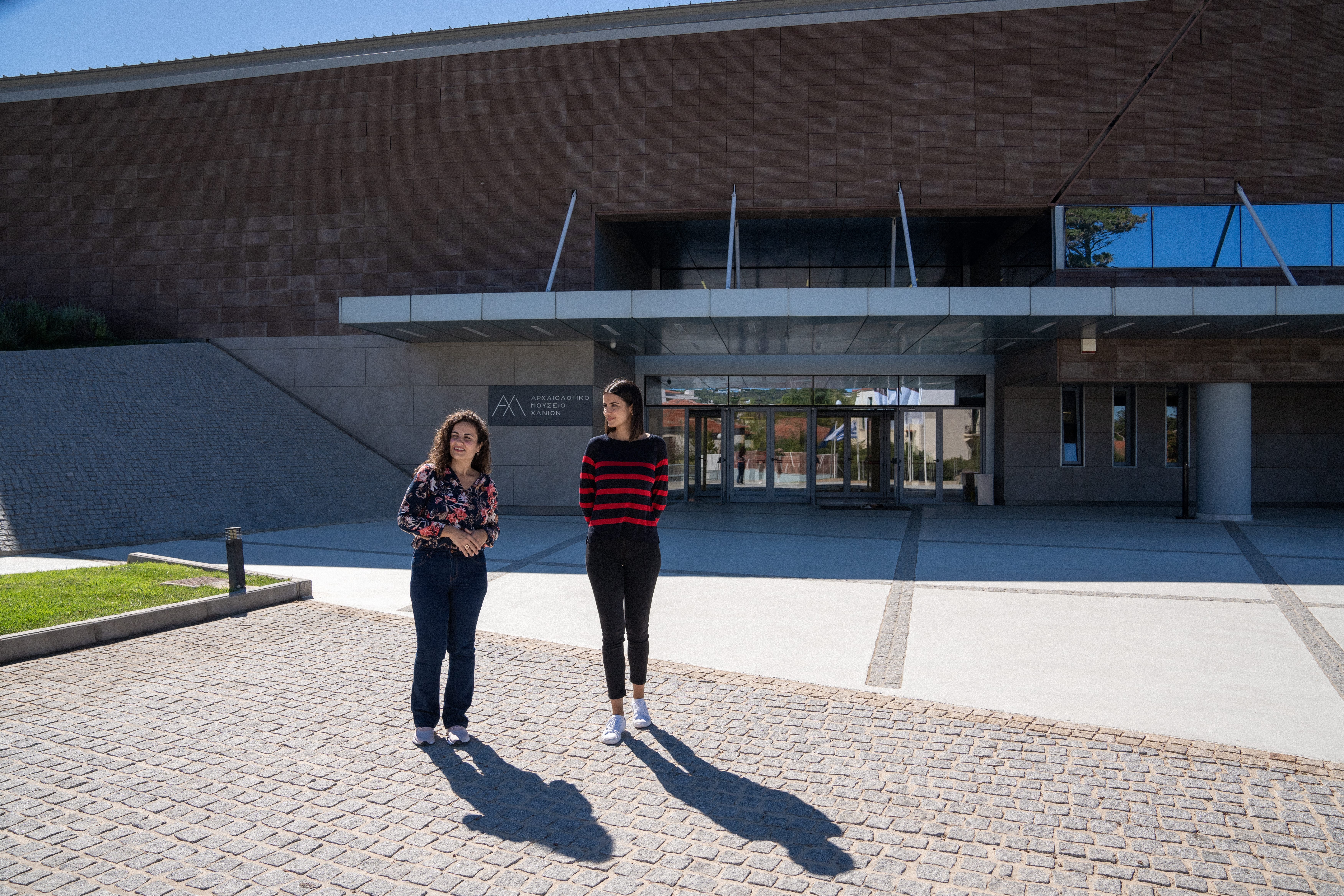 a man and a woman standing in front of a building