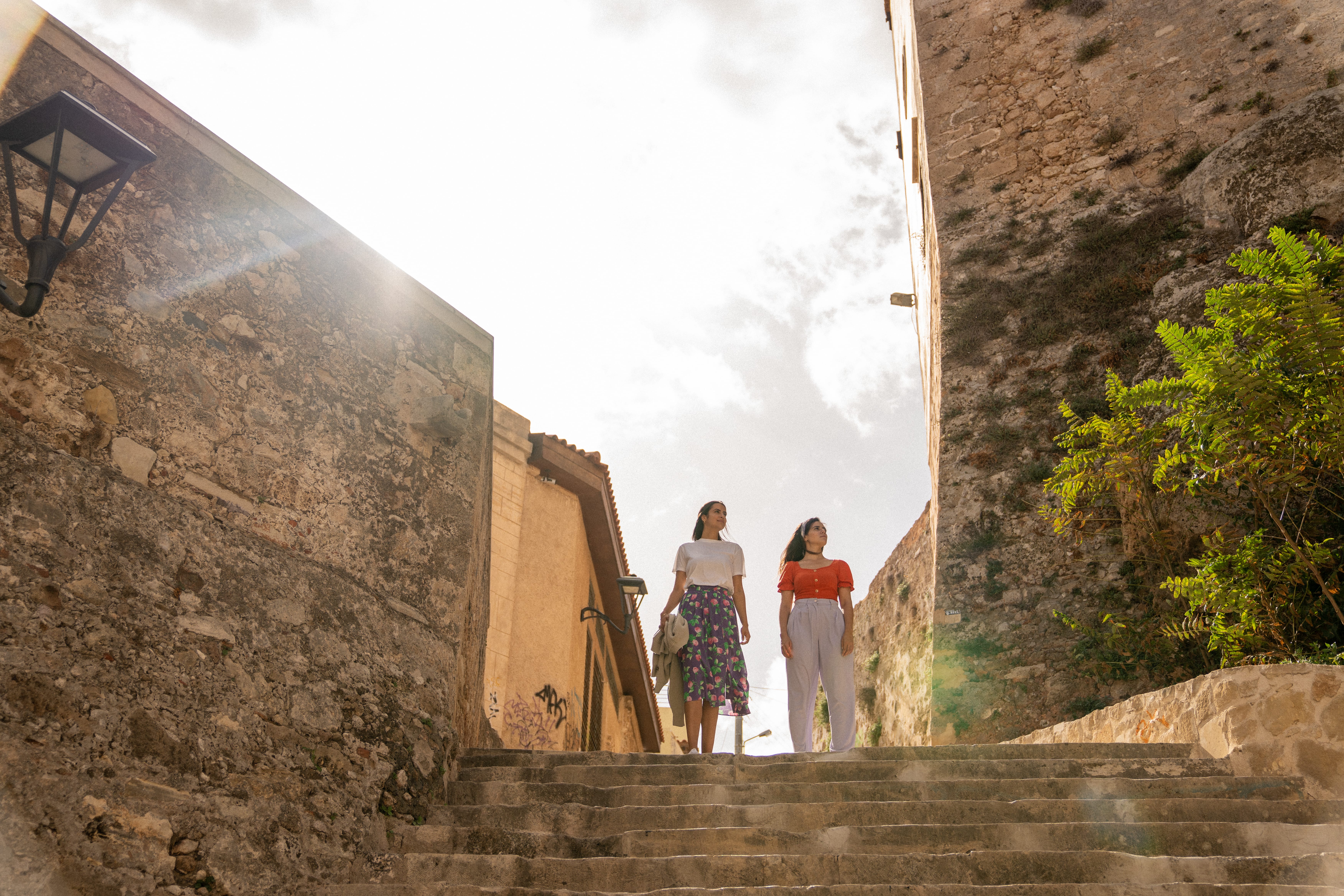 a couple of women standing on a stone staircase