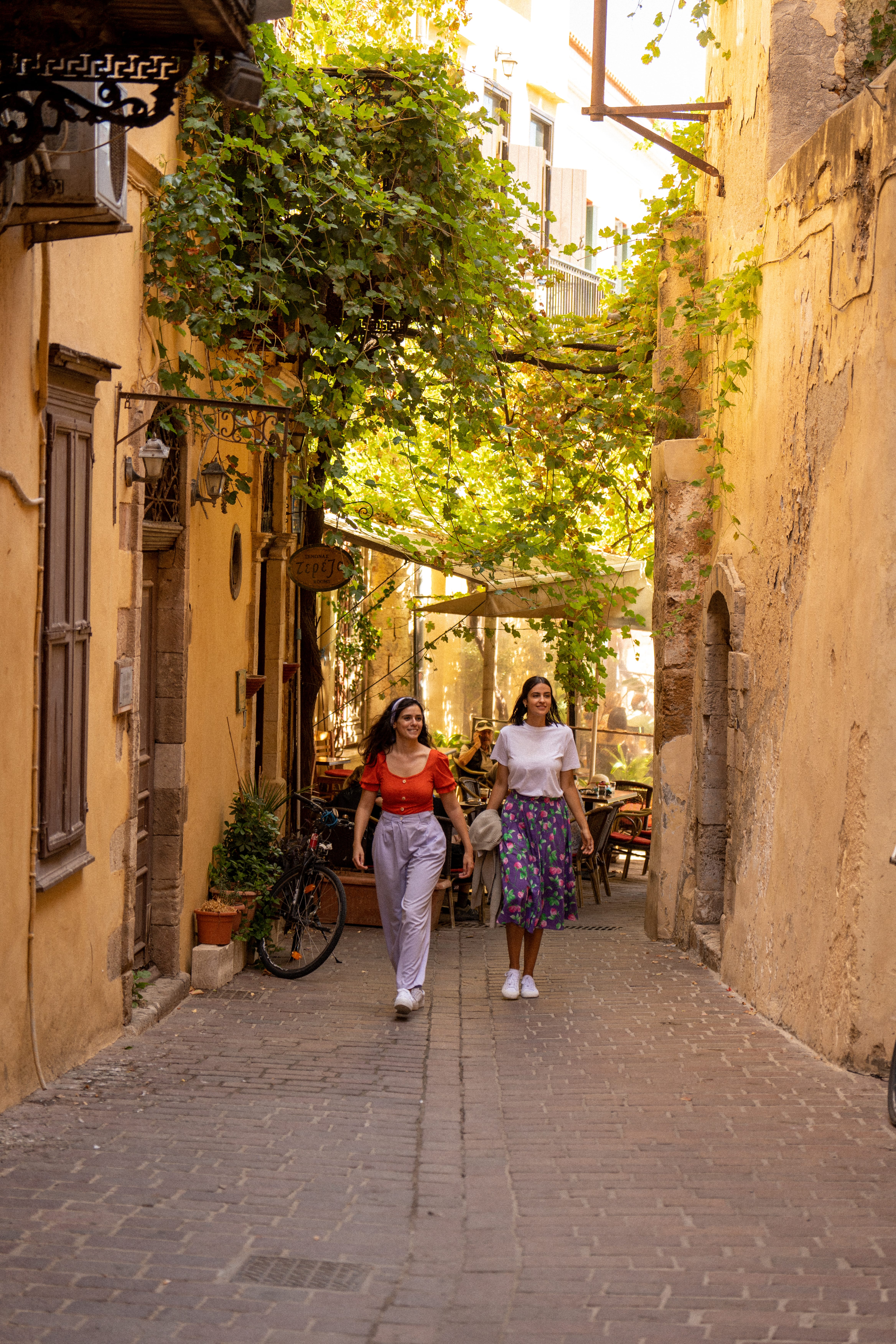 two women walking down a street