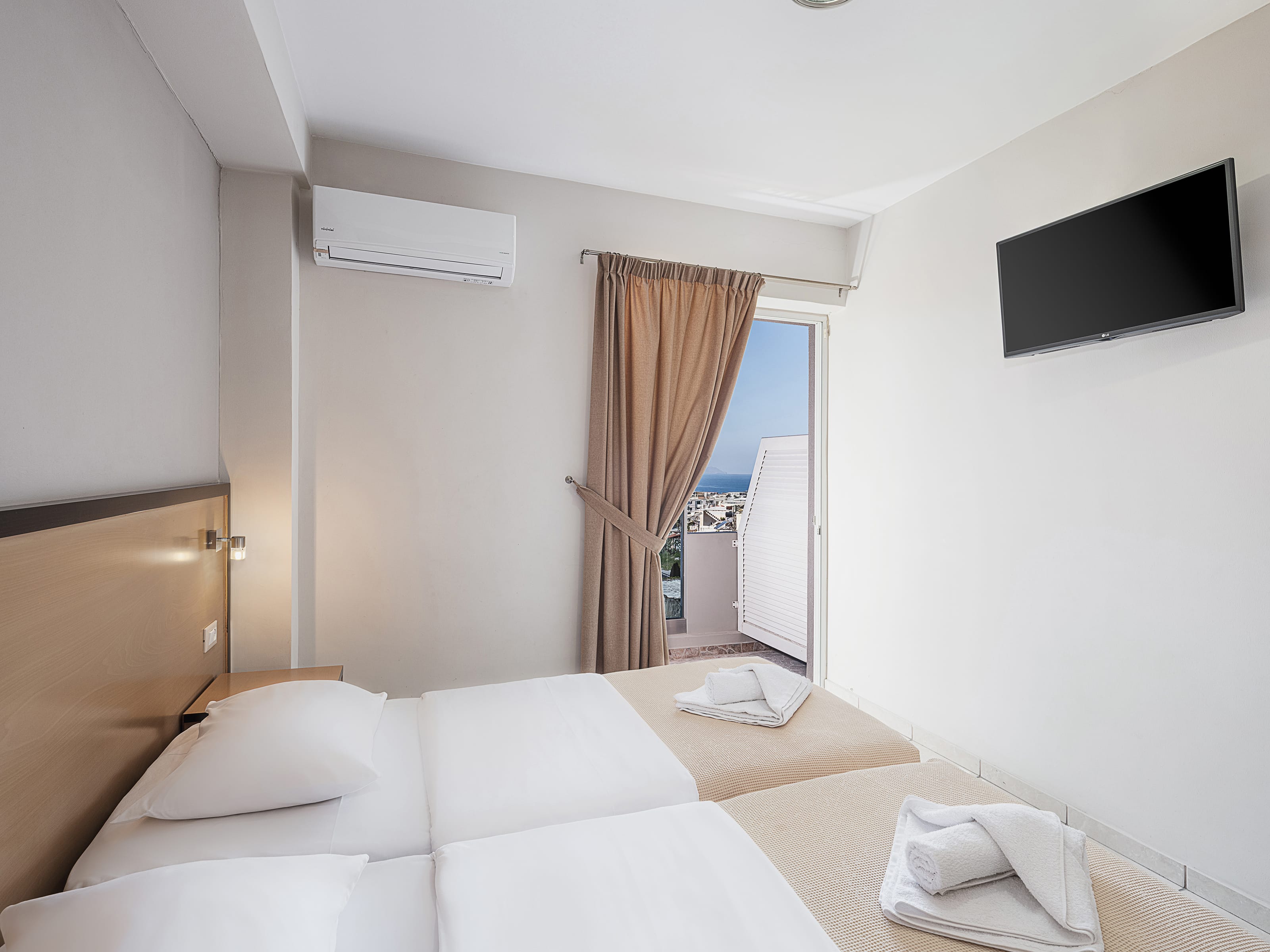 a hotel room with a tv and bed