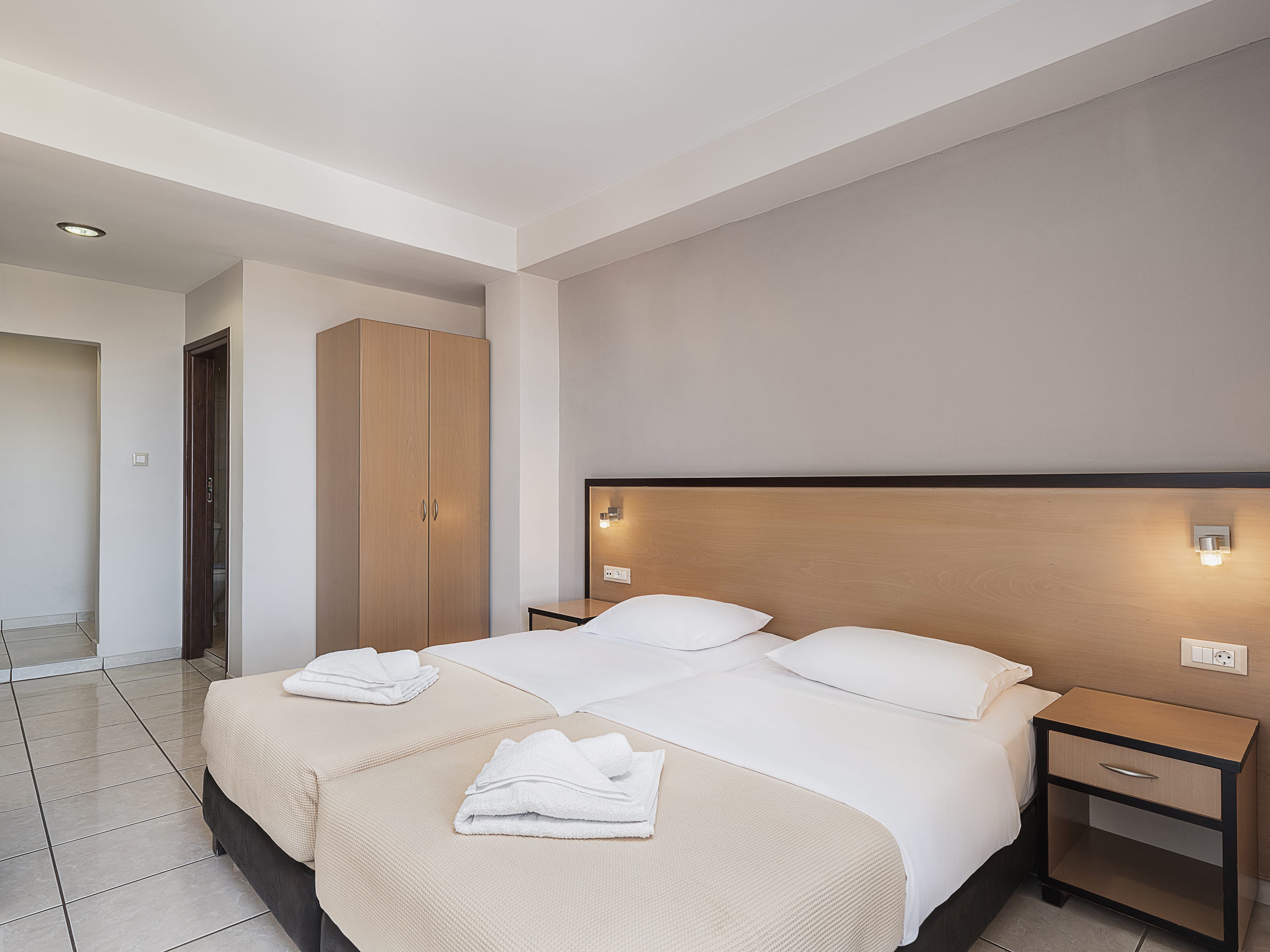 a hotel room with a bed and a desk
