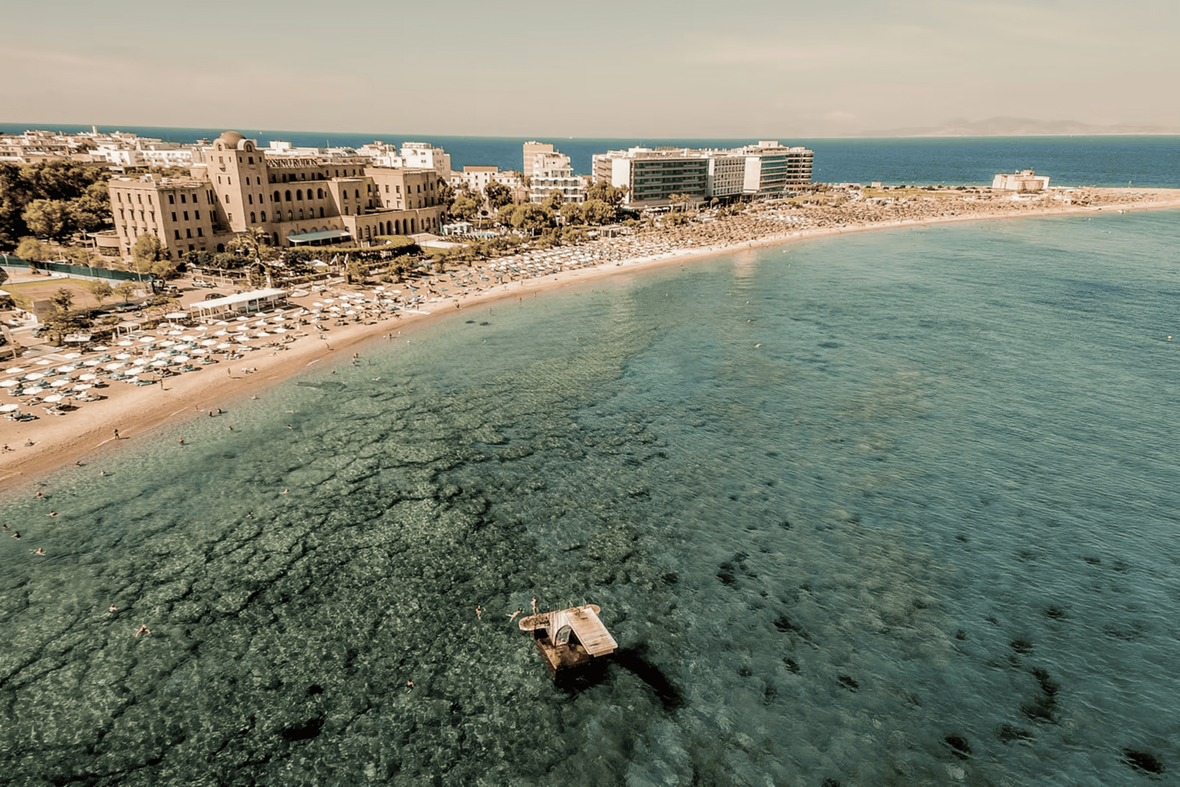 a beach with buildings and water