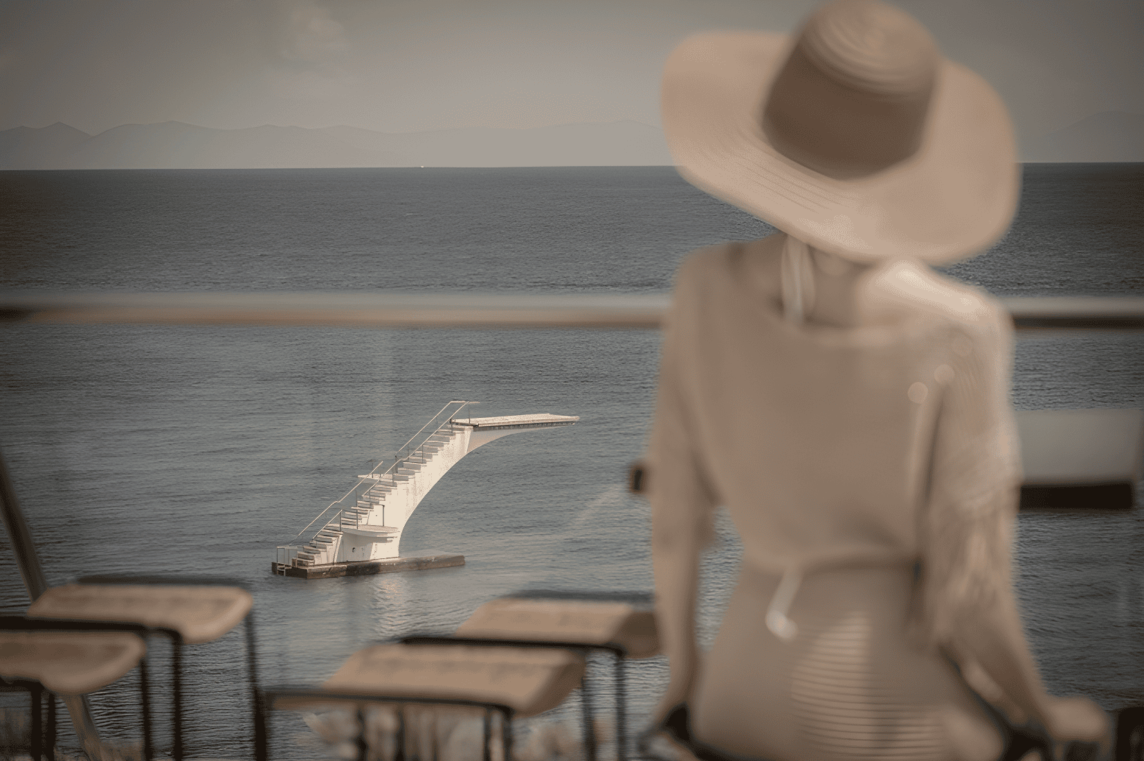 a person in a hat looking out at the water