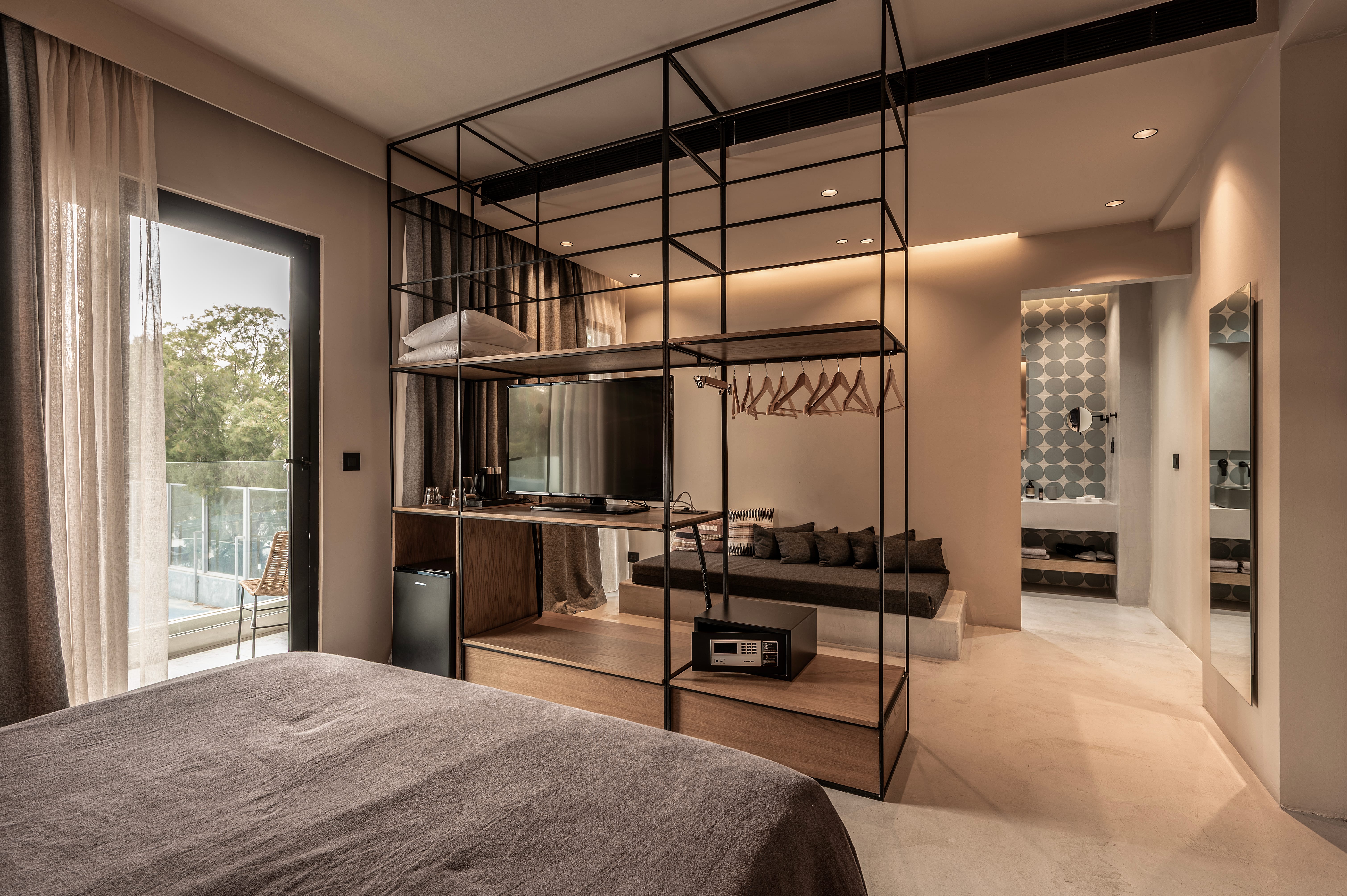 a bedroom with a bed and a tv