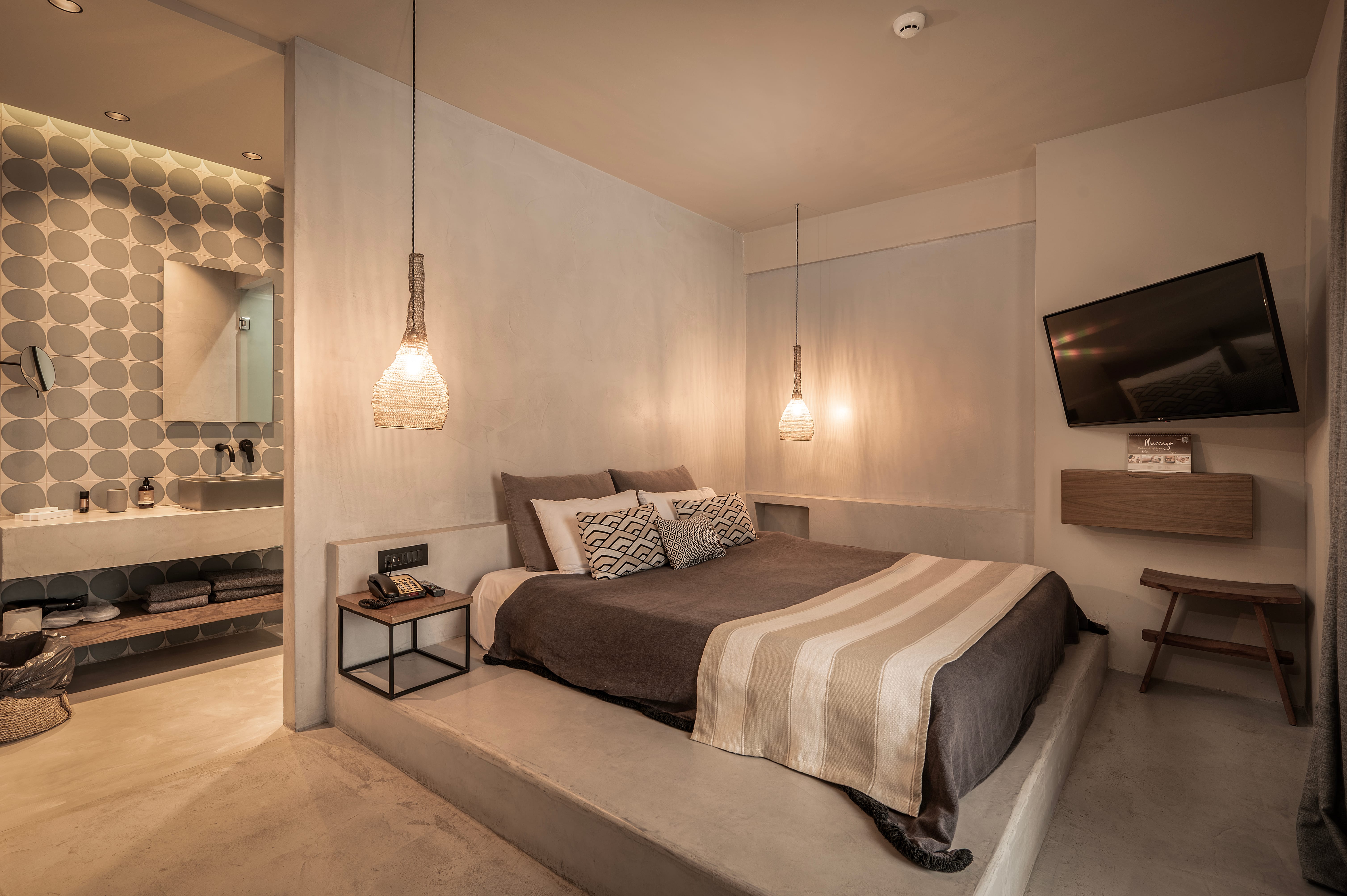 a bedroom with a bed and a tv