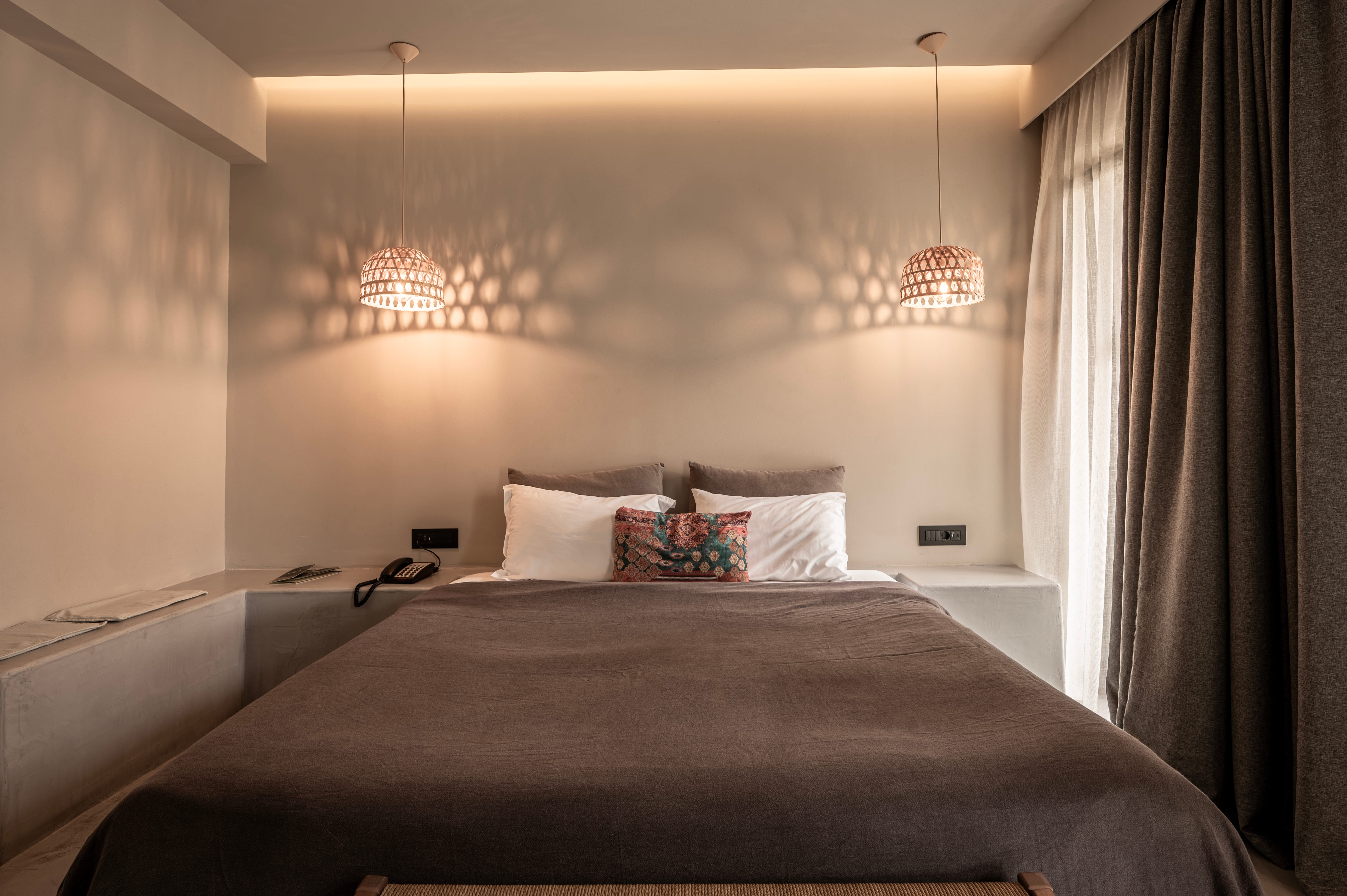 a bed with a chandelier above it
