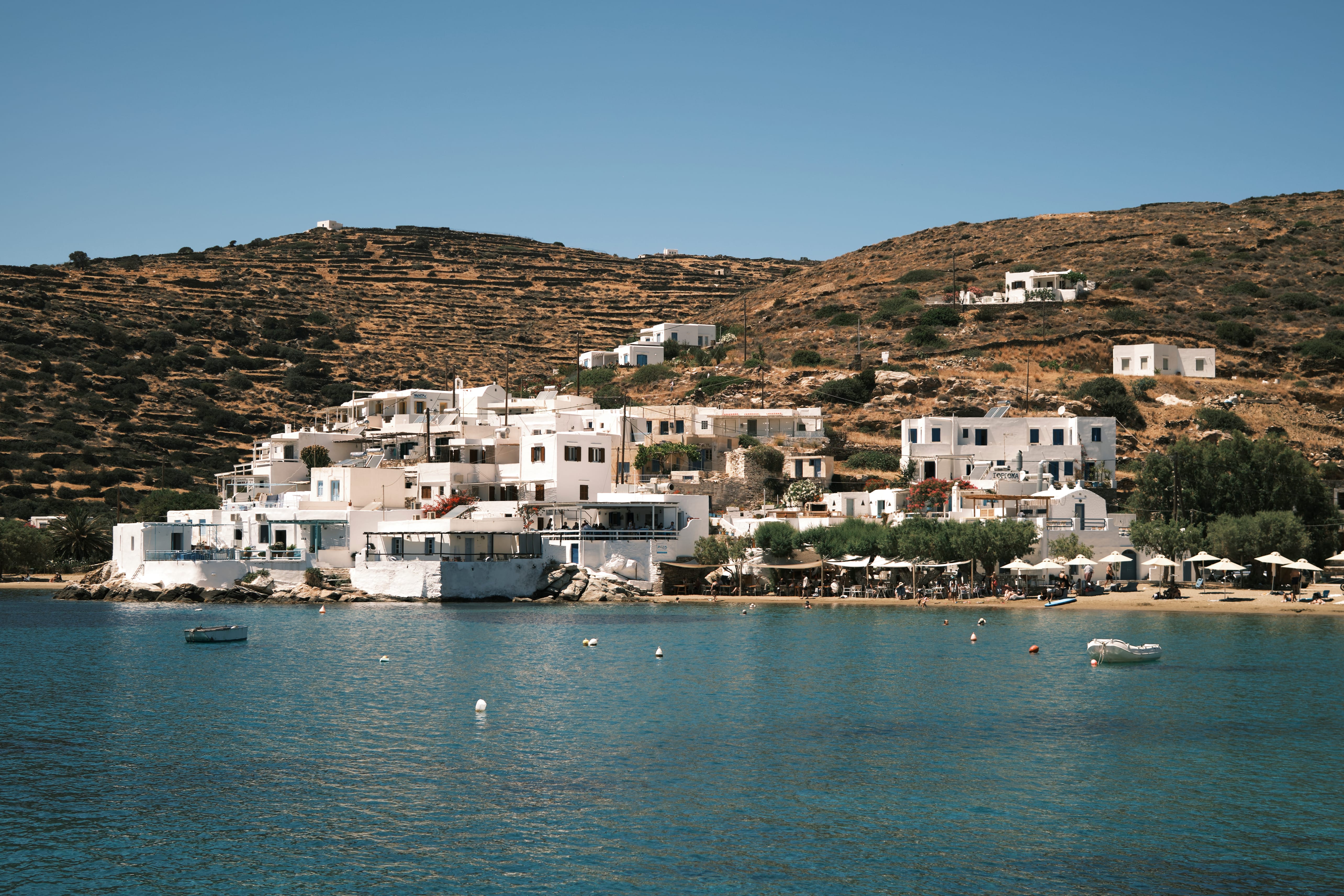 a white buildings next to a body of water