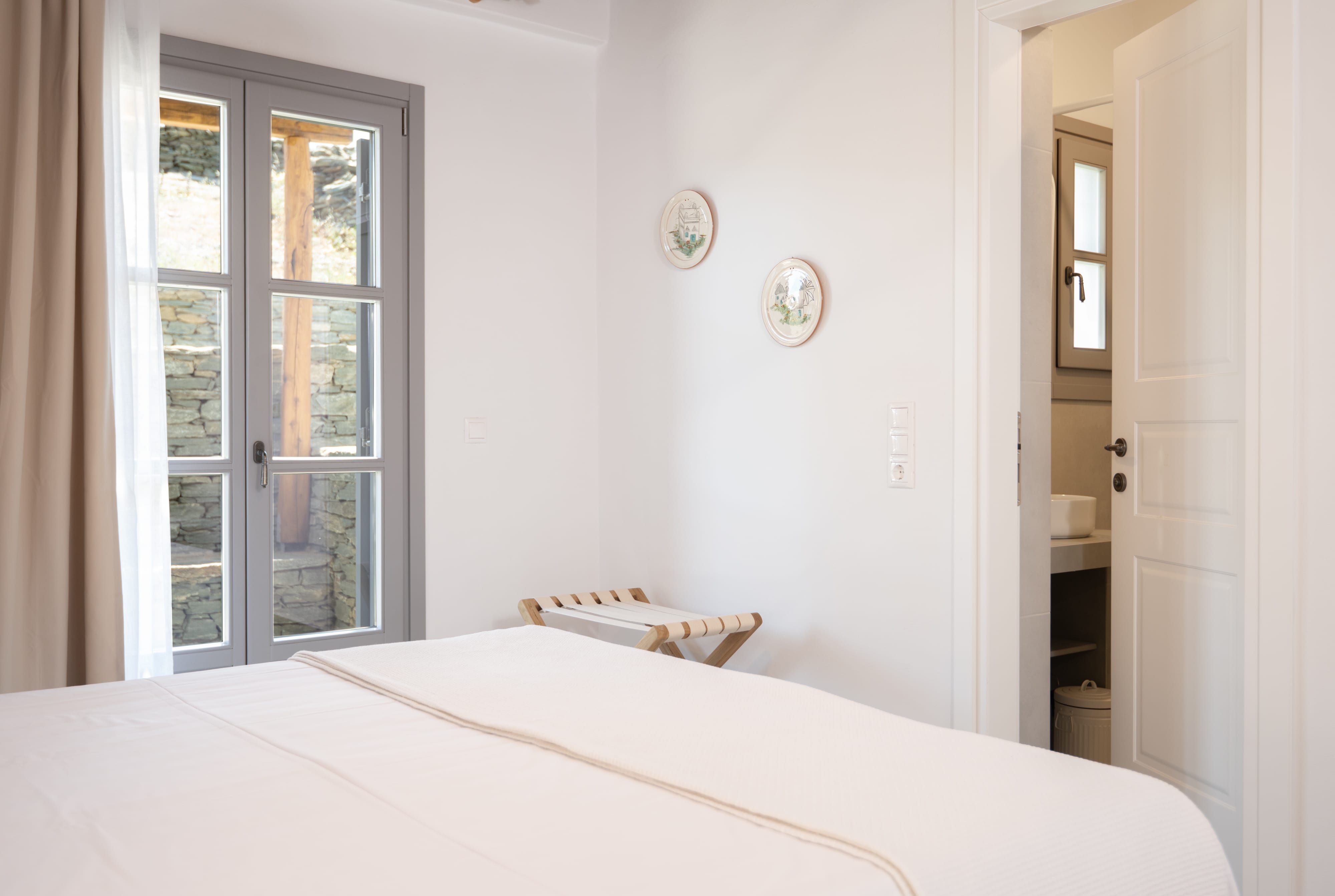 a bedroom with a bed and a glass door