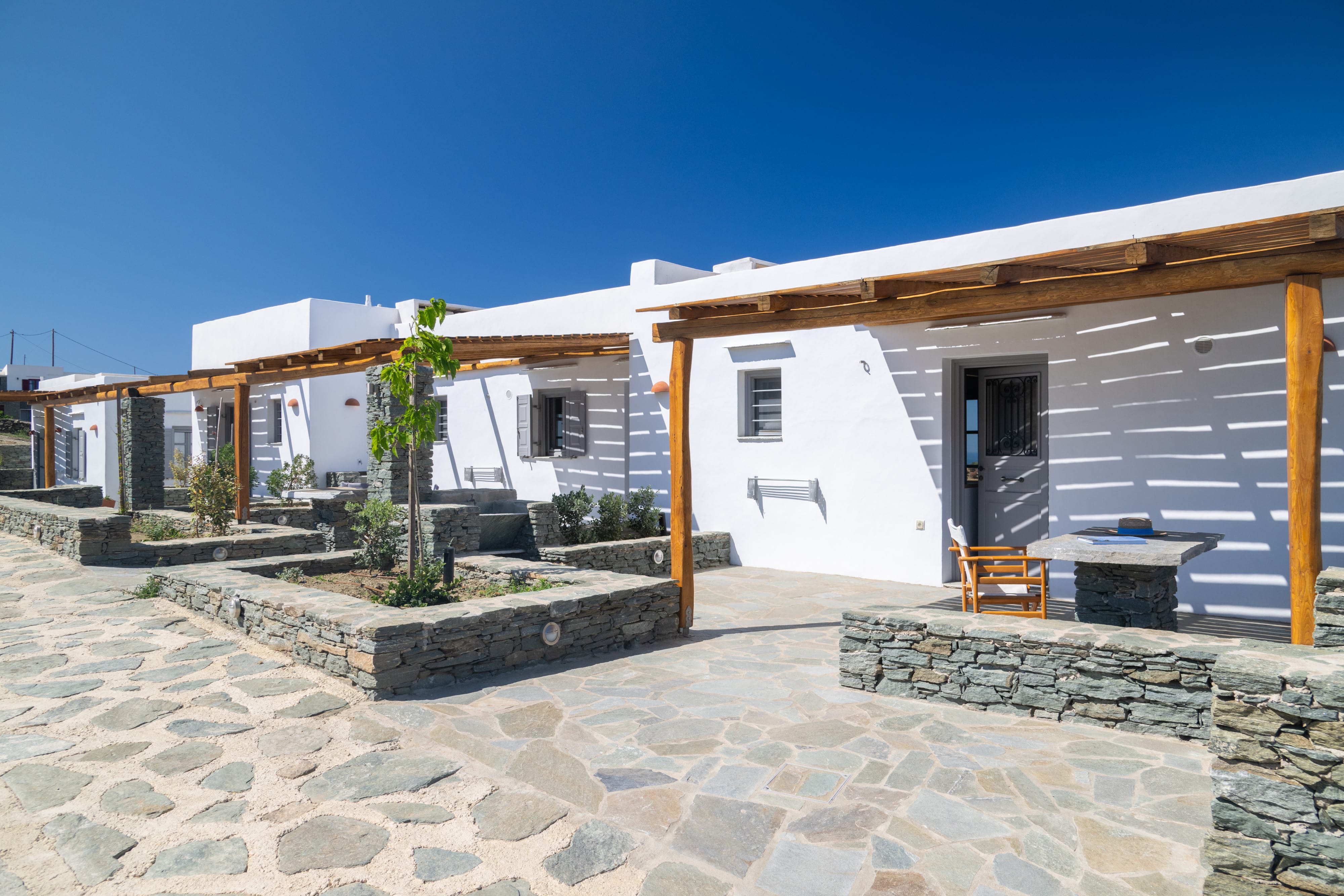 a white house with stone patio