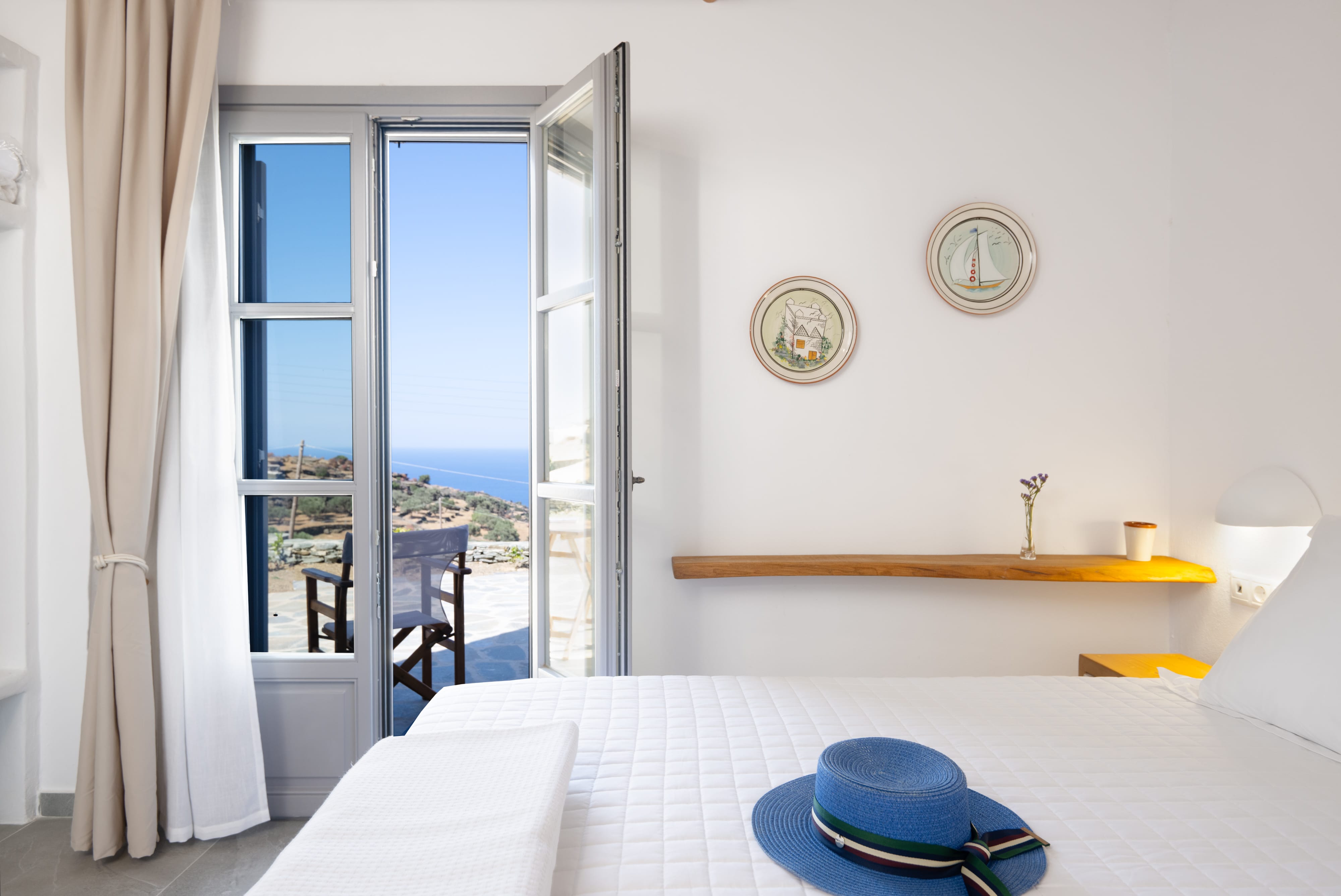 a bedroom with a hat on a bed