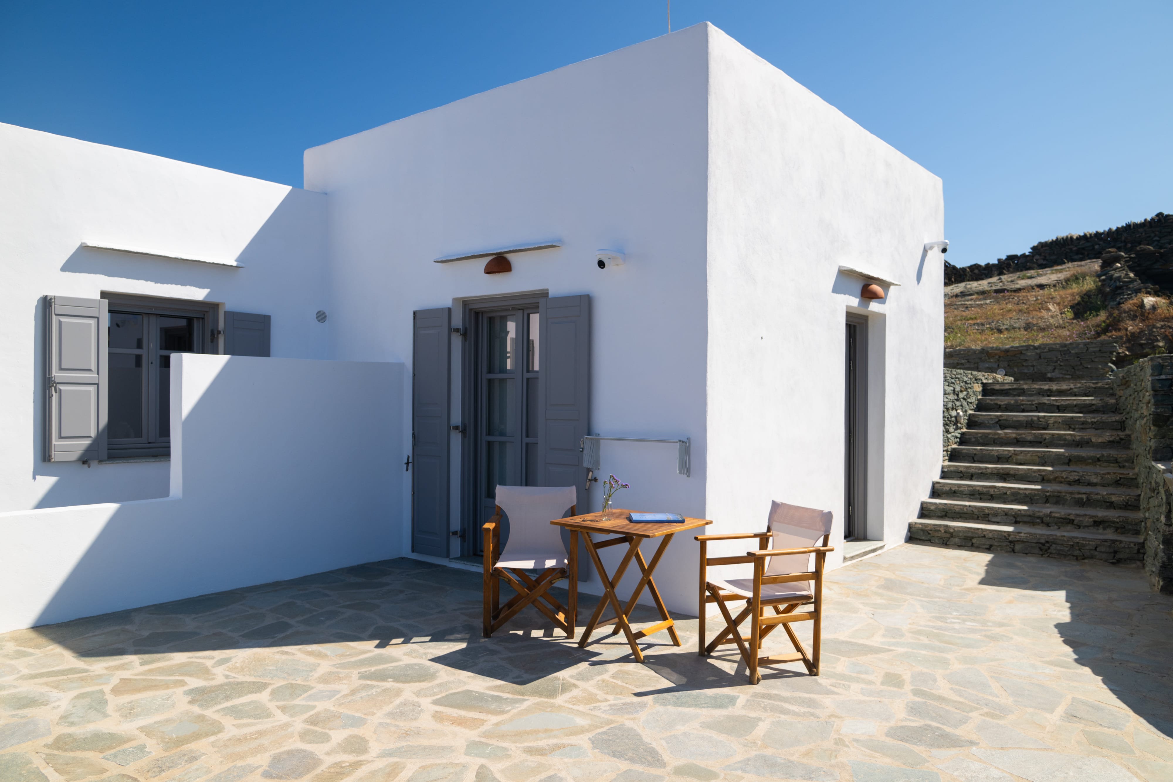 a white building with a table and chairs