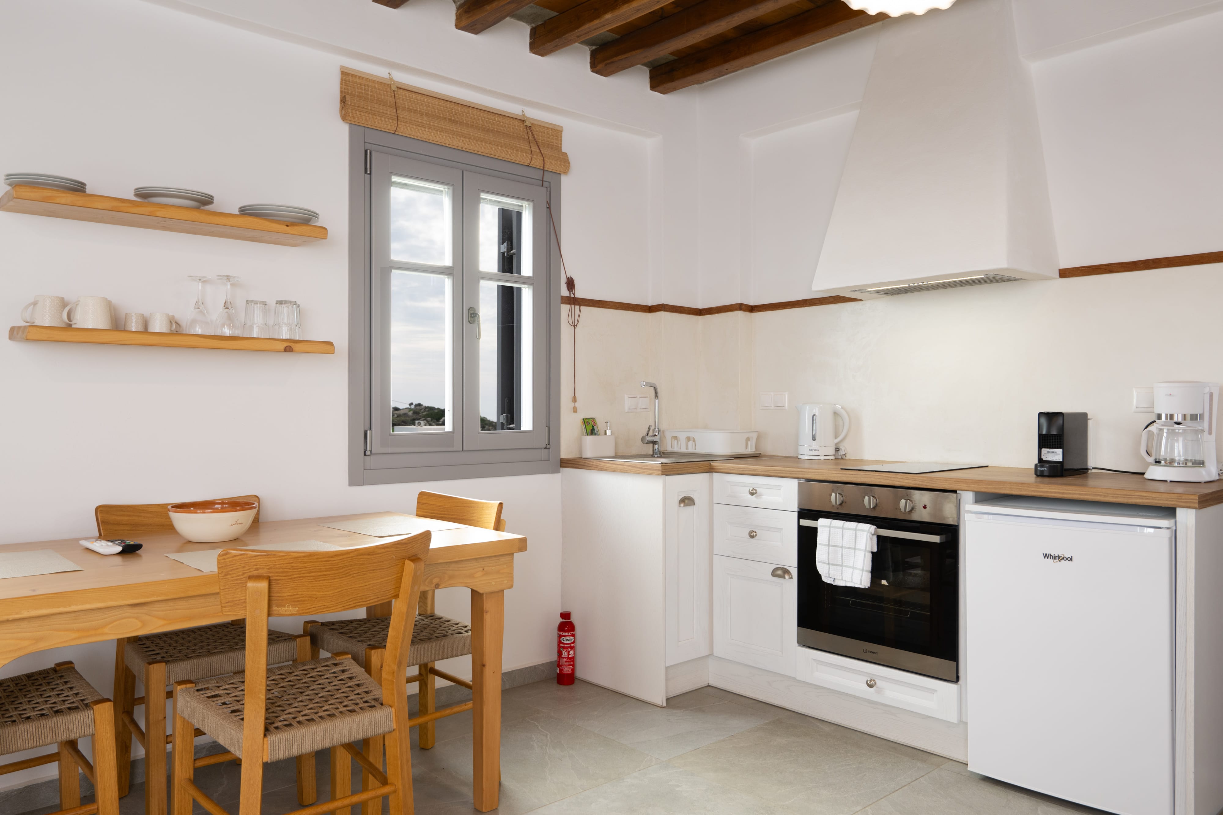 a kitchen with a table and chairs
