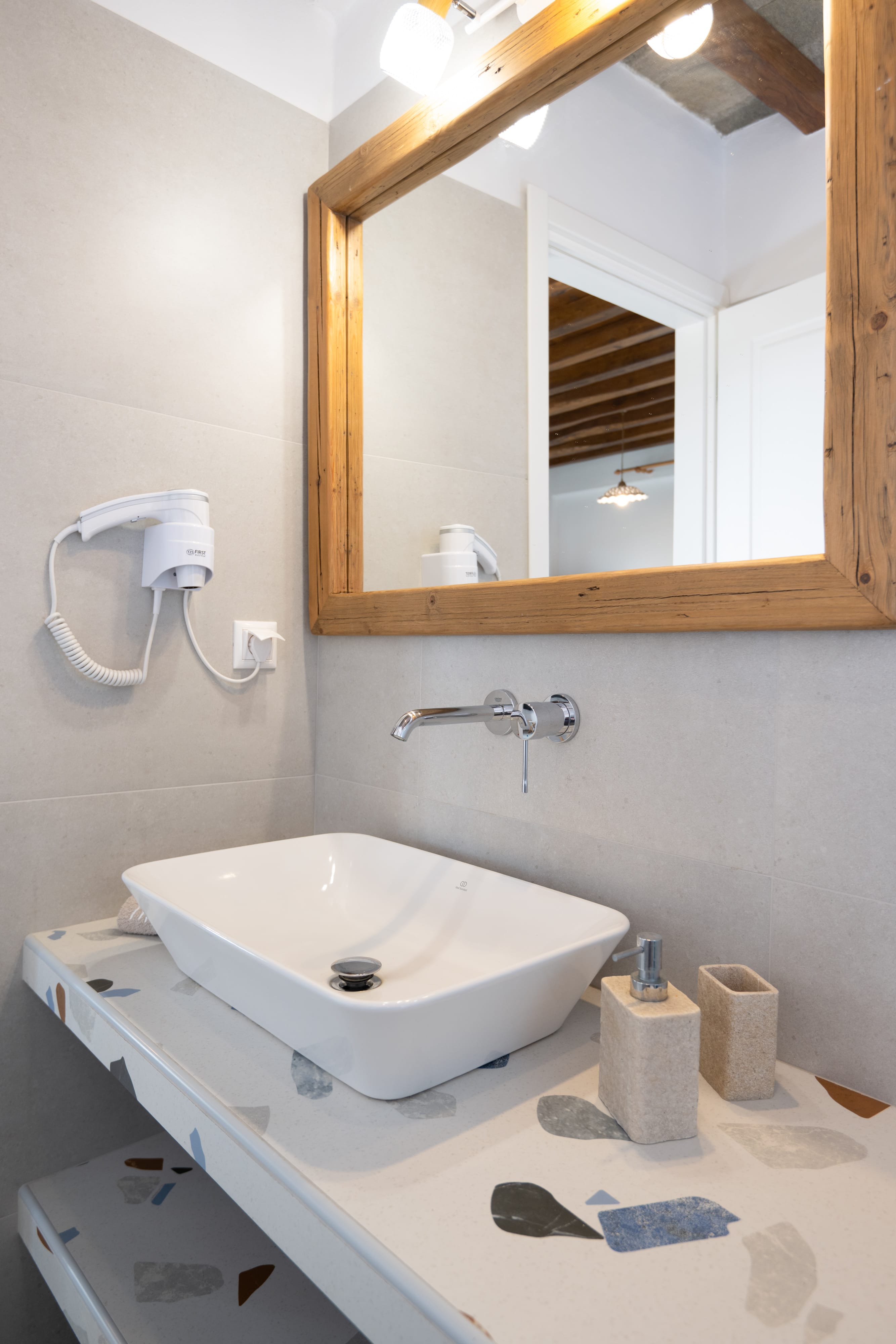 a bathroom with a mirror and a sink