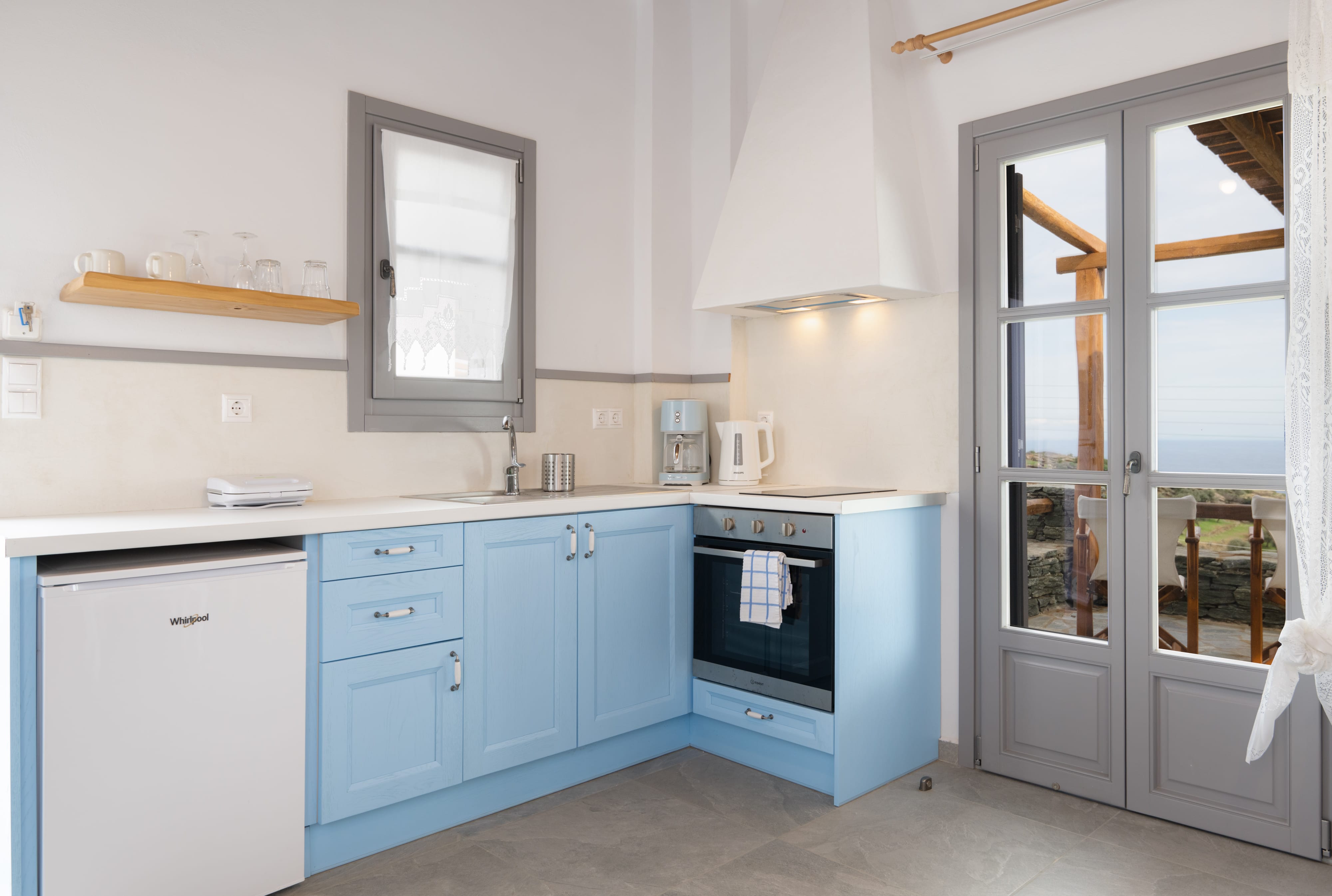 a kitchen with blue cabinets and a door