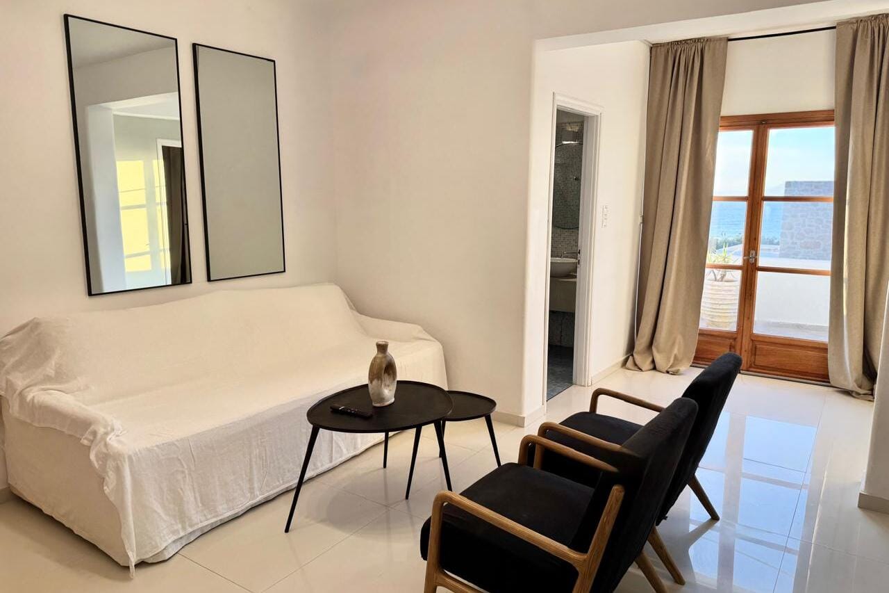 a room with a couch and chairs