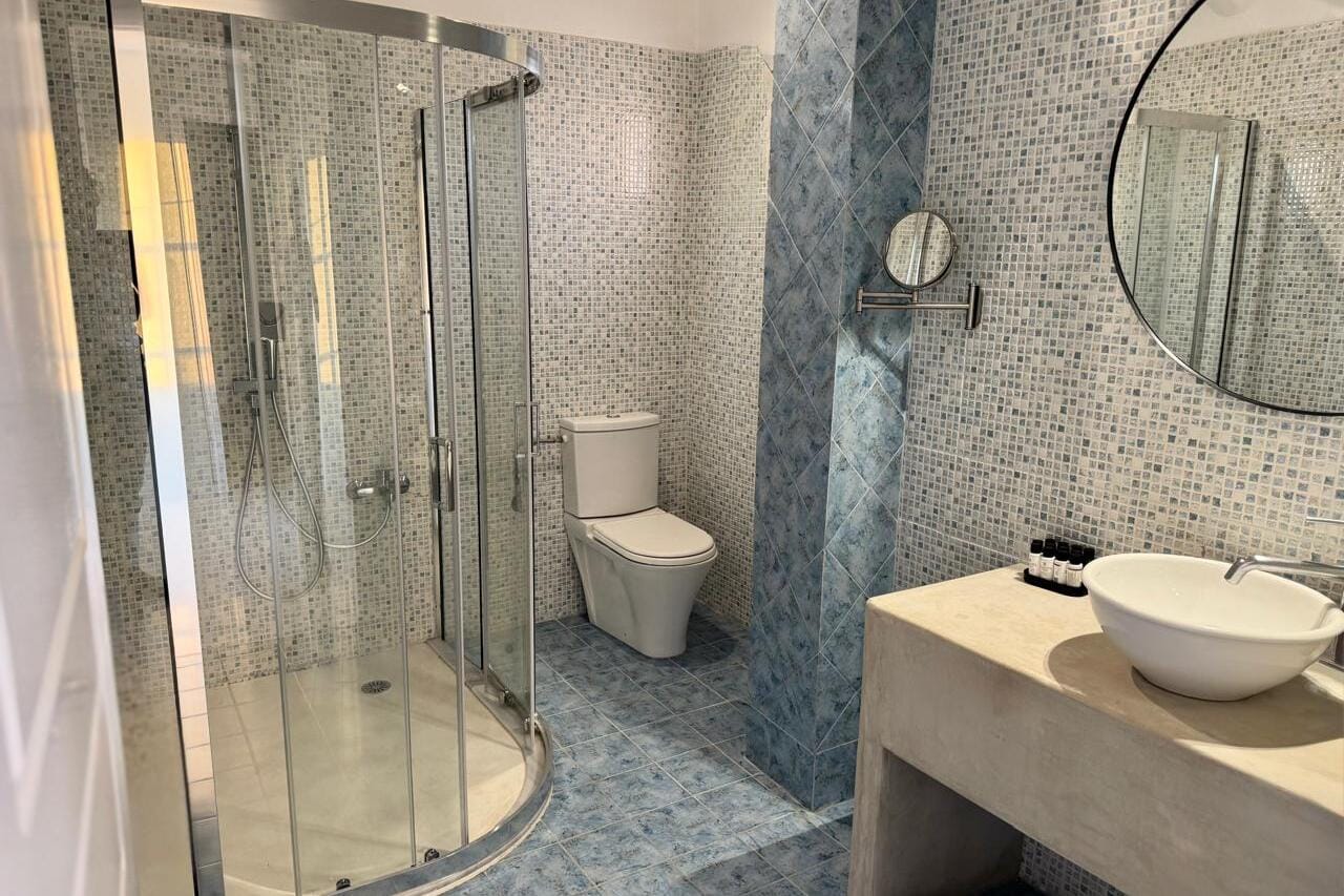a bathroom with a shower and sink
