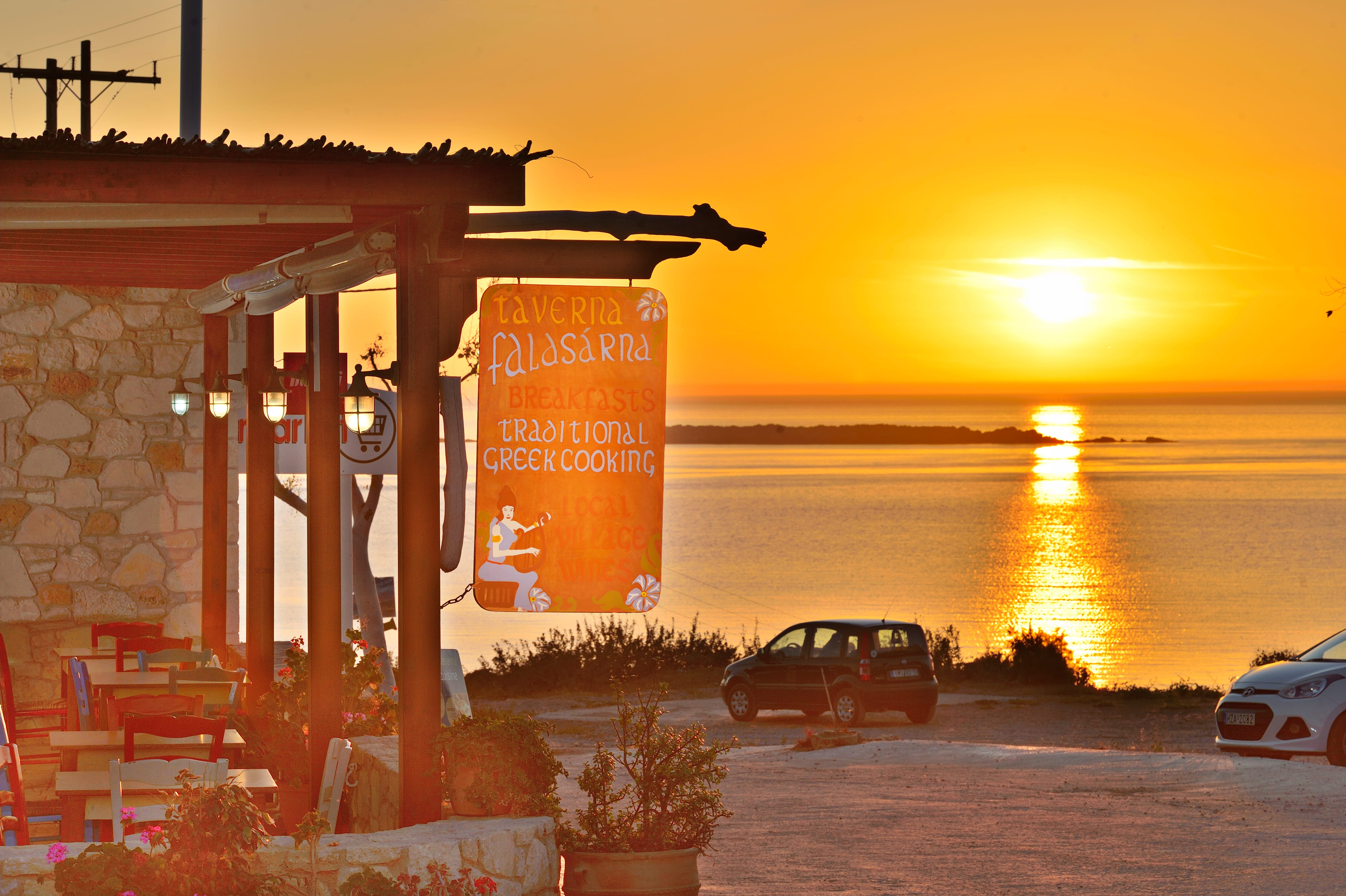 a restaurant with a sunset in the background
