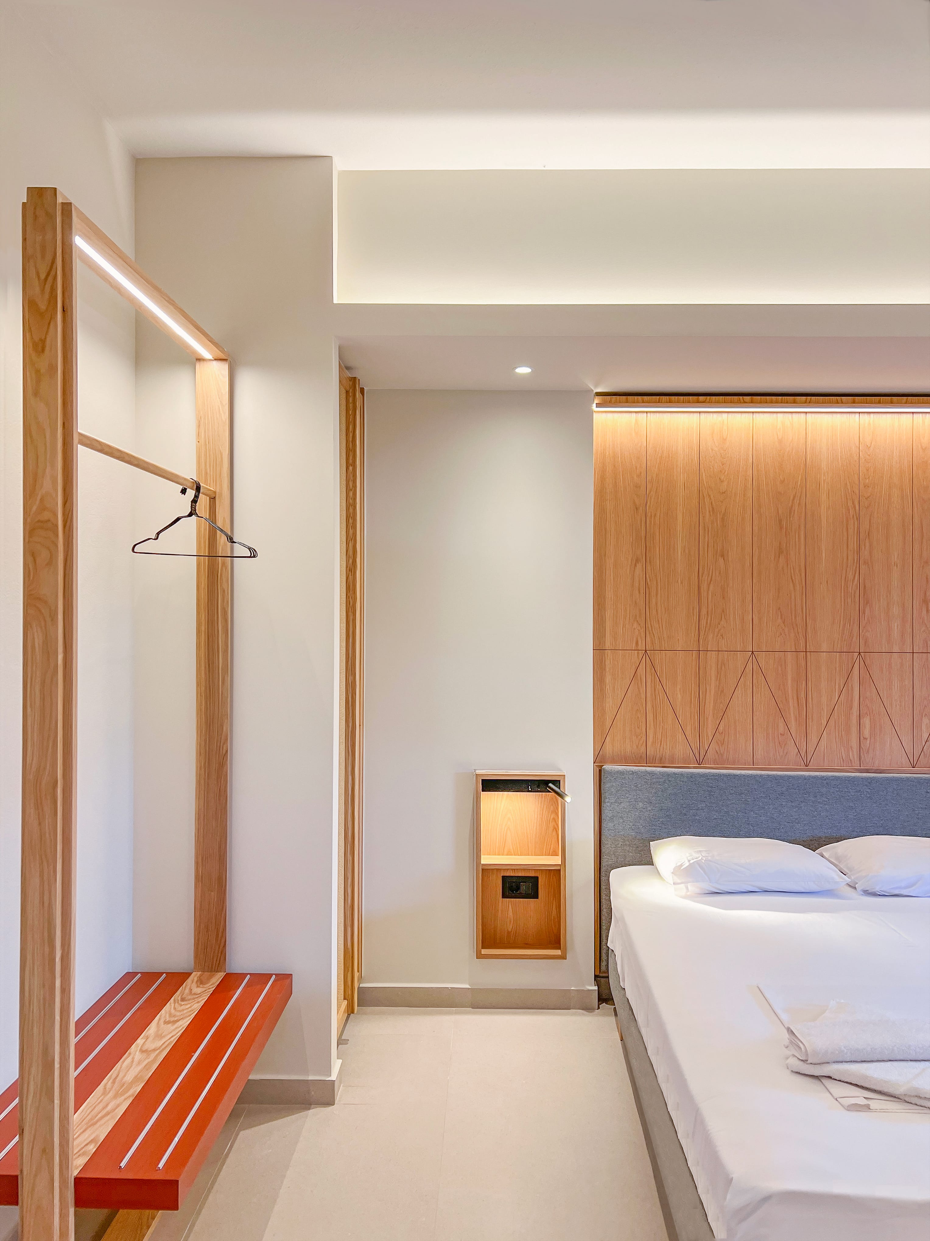 a bedroom with a bed and a bench