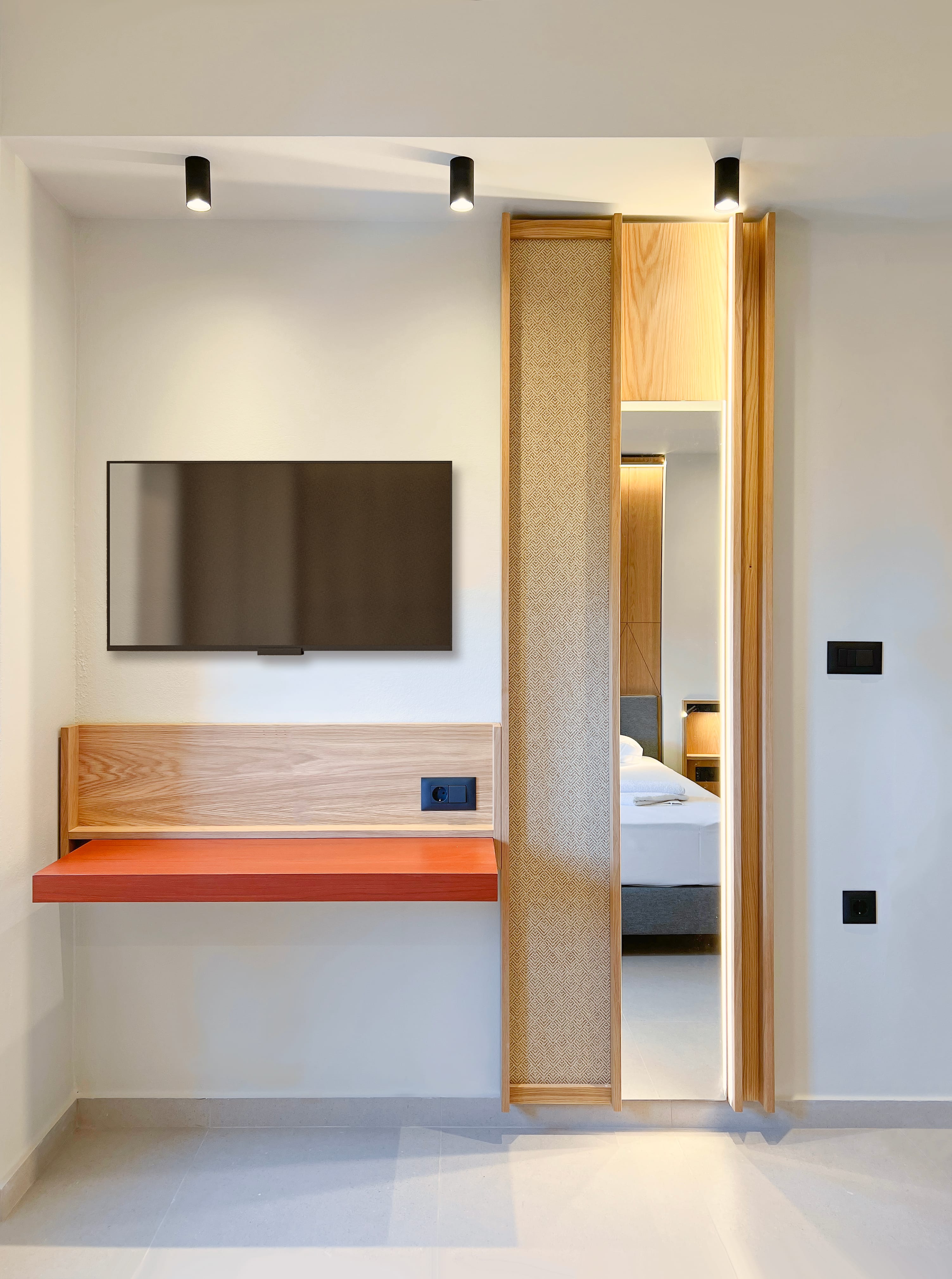 a room with a bed and a mirror