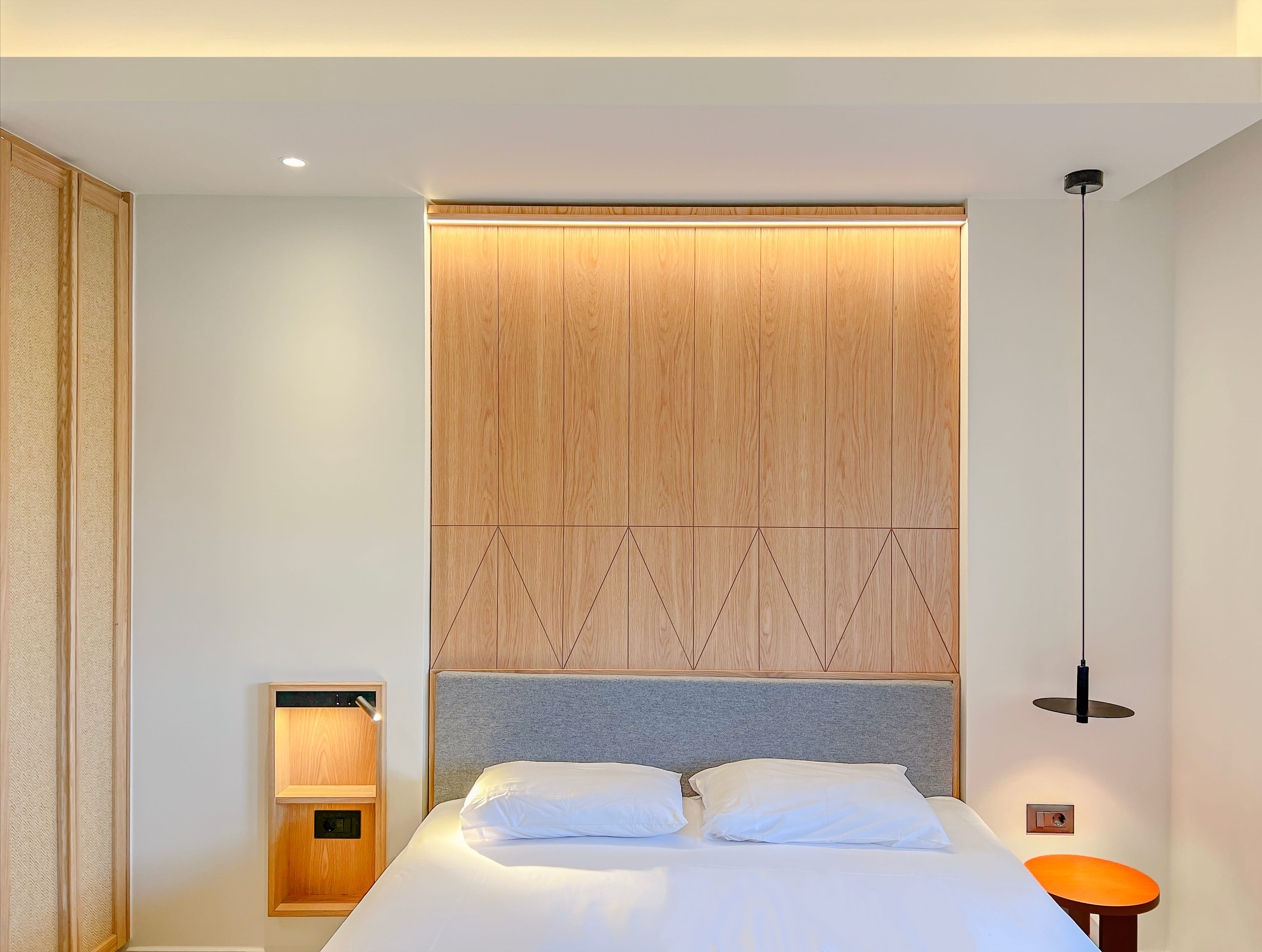 a bedroom with a bed and a lamp