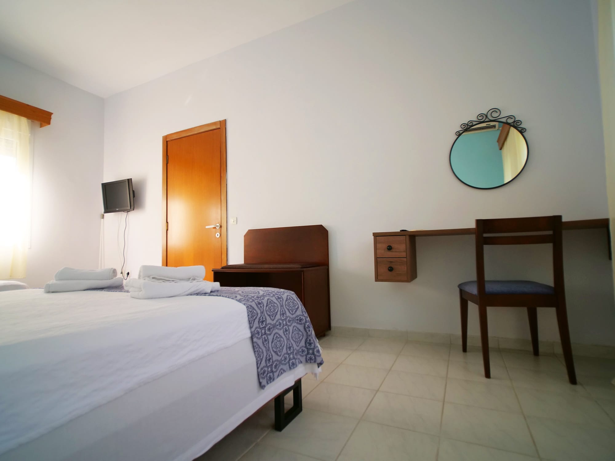 a bedroom with a mirror and a bed