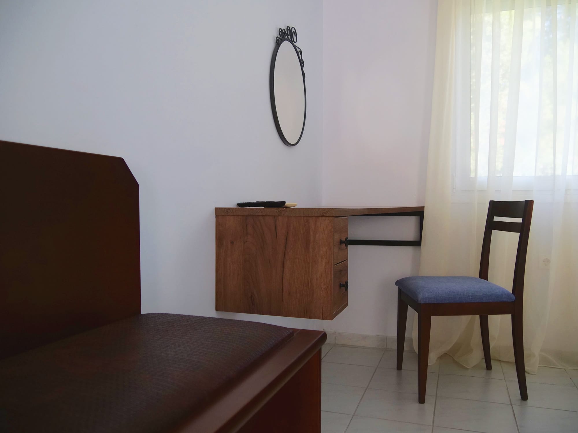 a room with a mirror and a chair