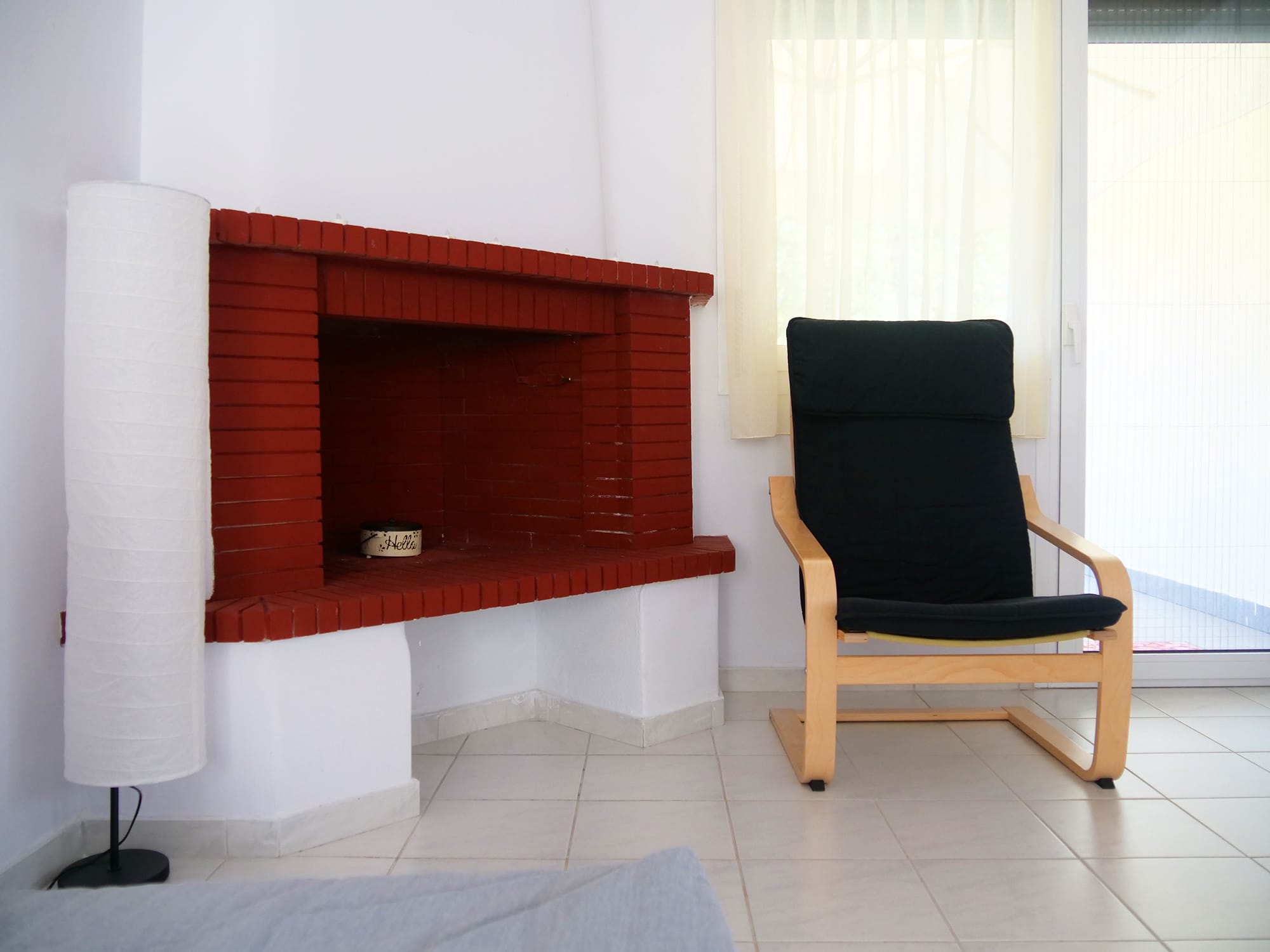 a chair next to a fireplace