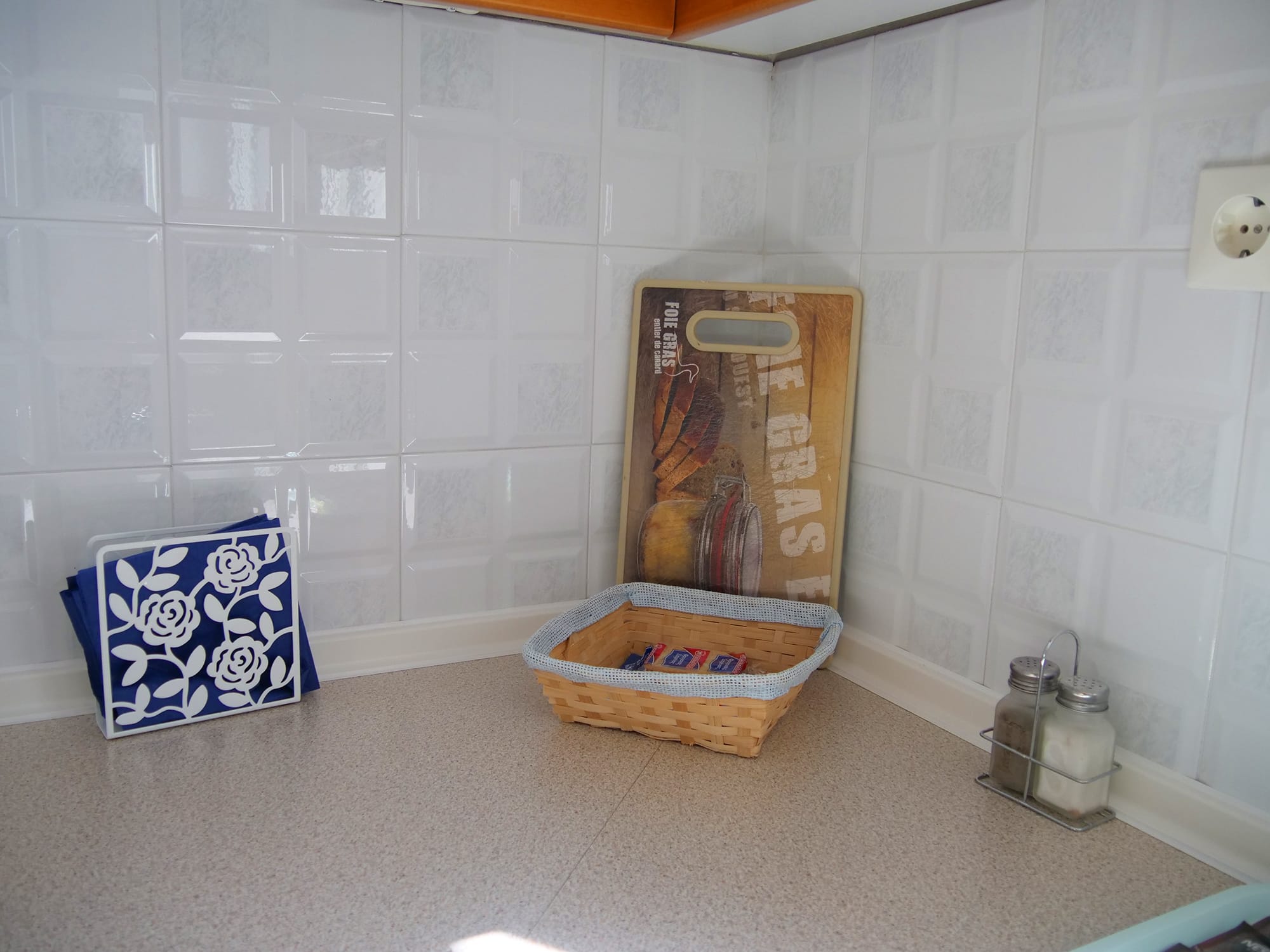 a basket and a cutting board in a corner of a kitchen