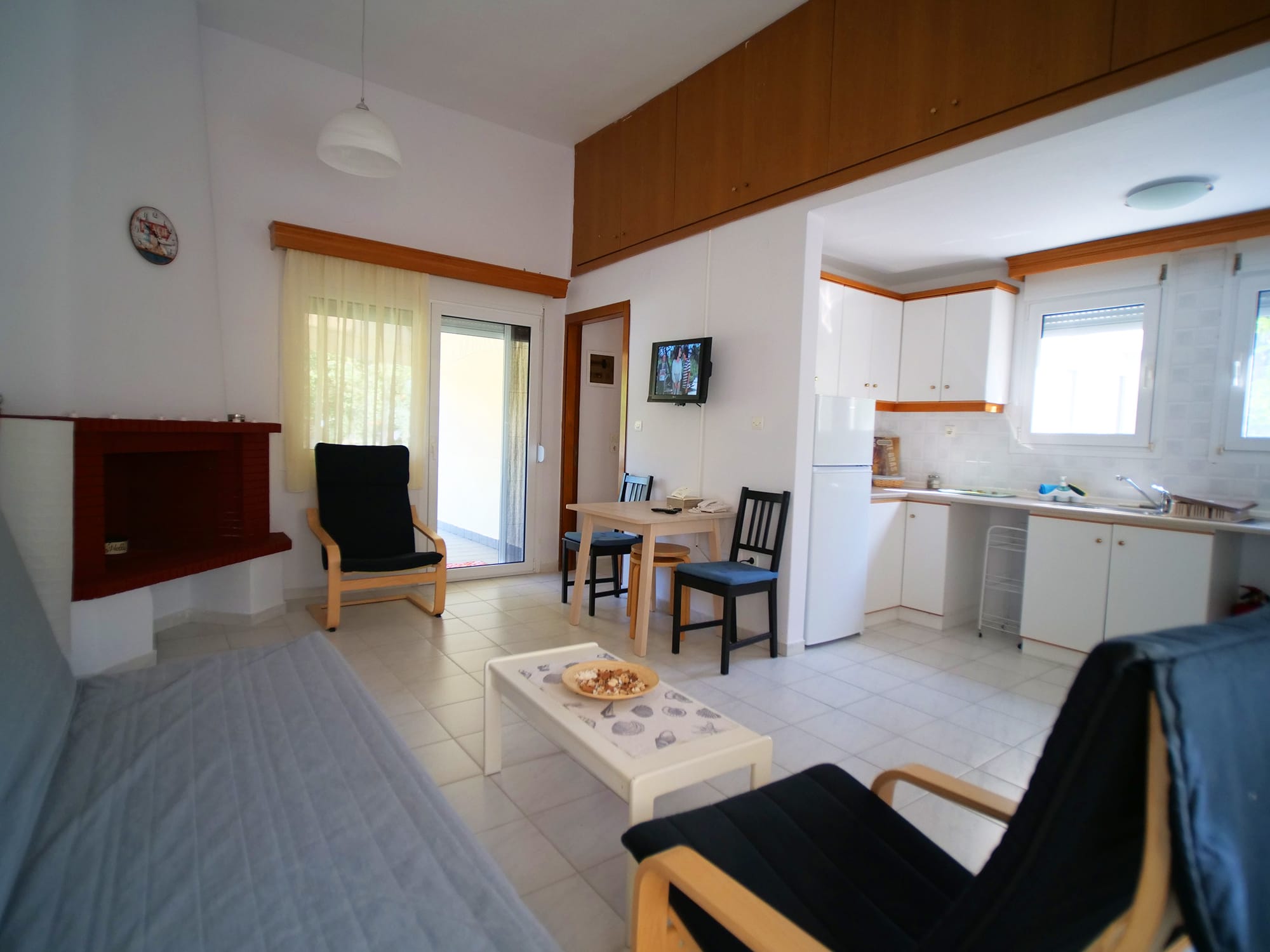 a room with a bed and chairs