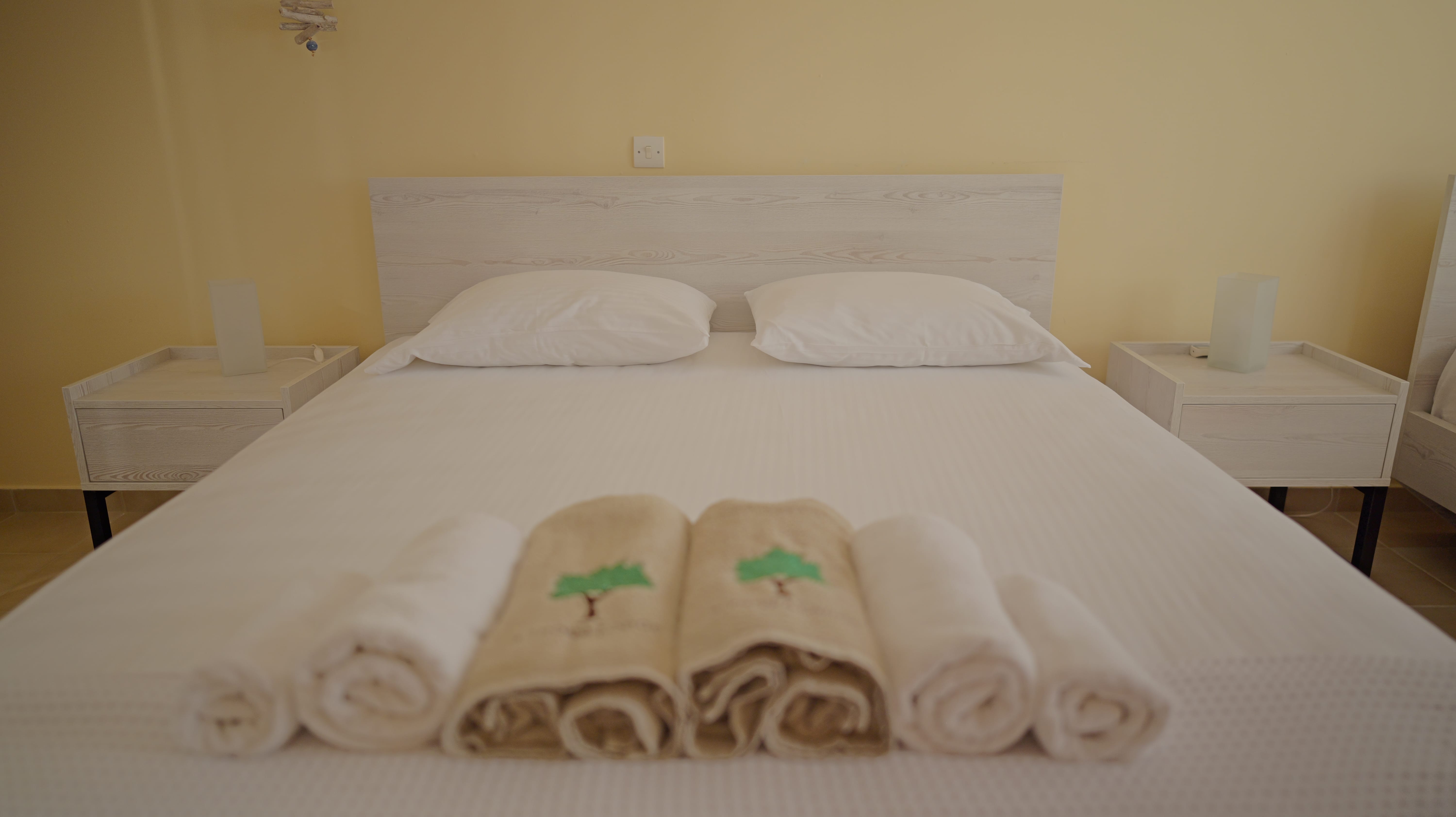 a bed with white towels and pillows