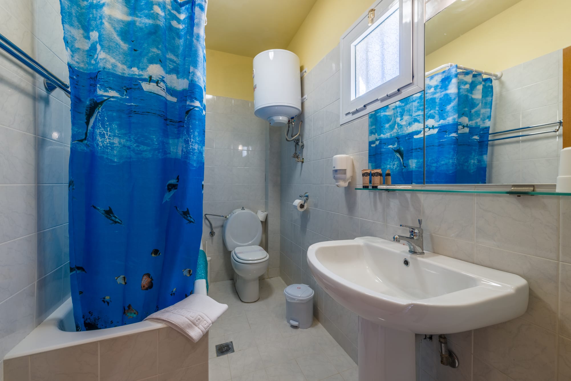 a bathroom with a shower curtain and sink
