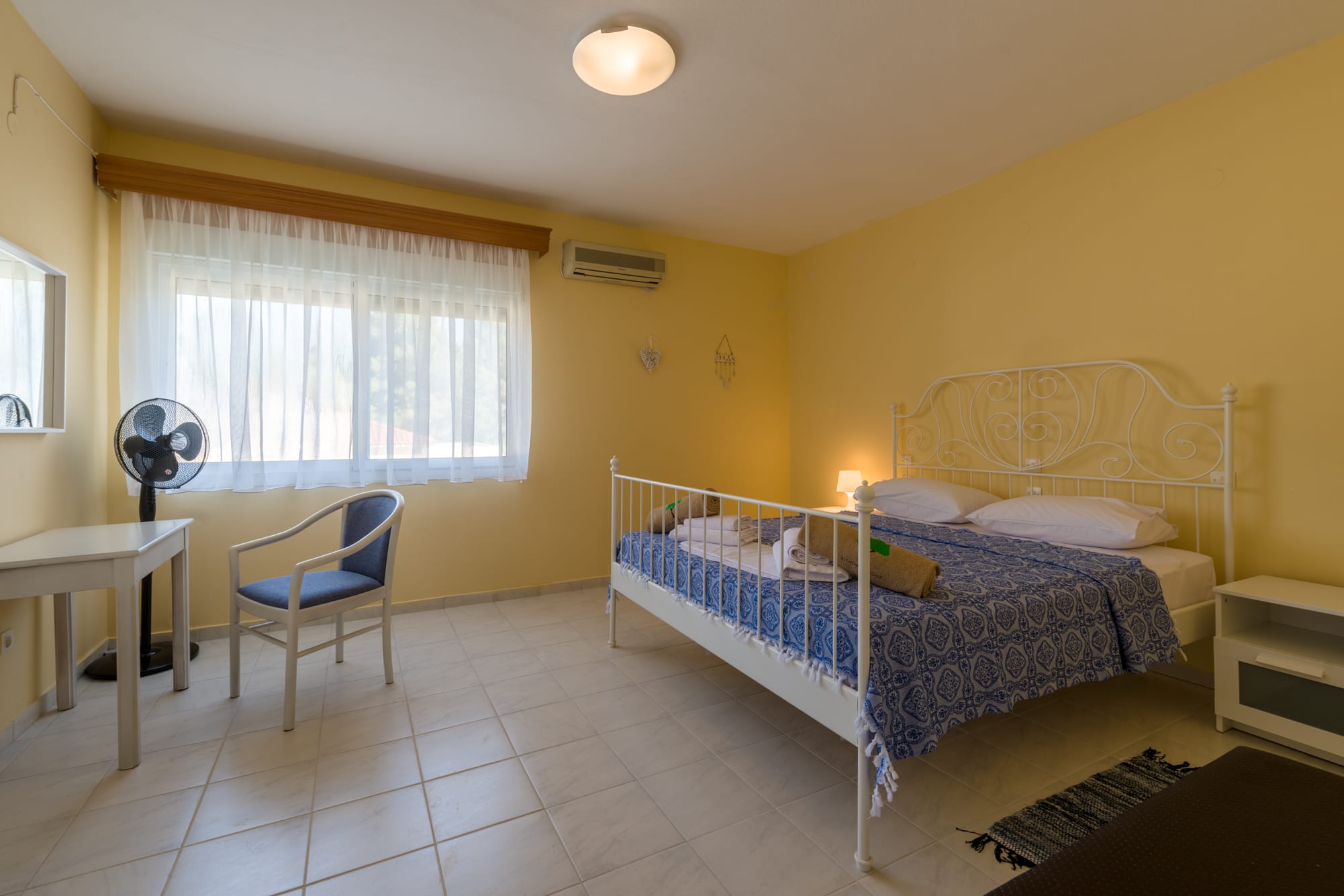 a bedroom with a bed and a chair