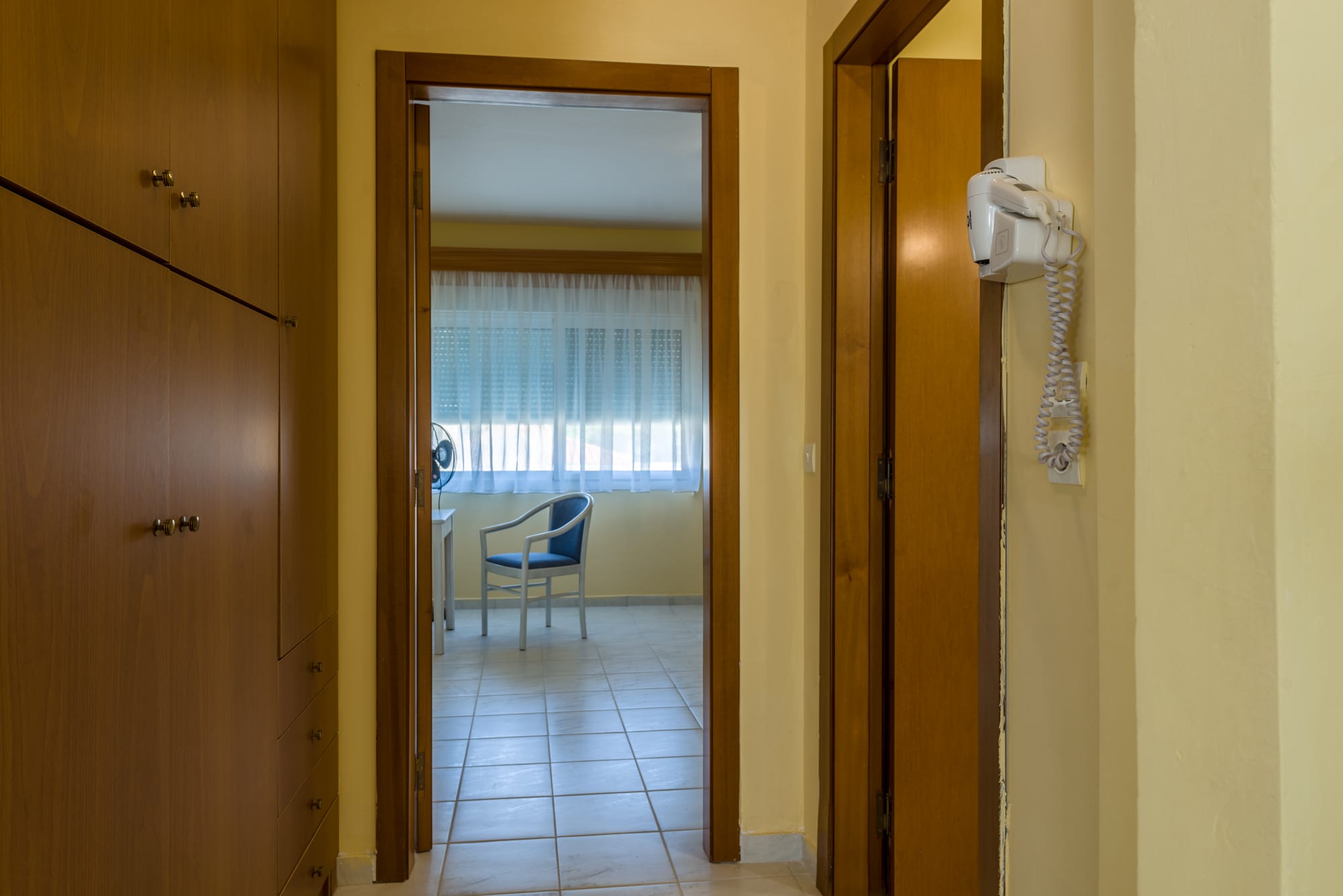 a hallway with a chair and a table