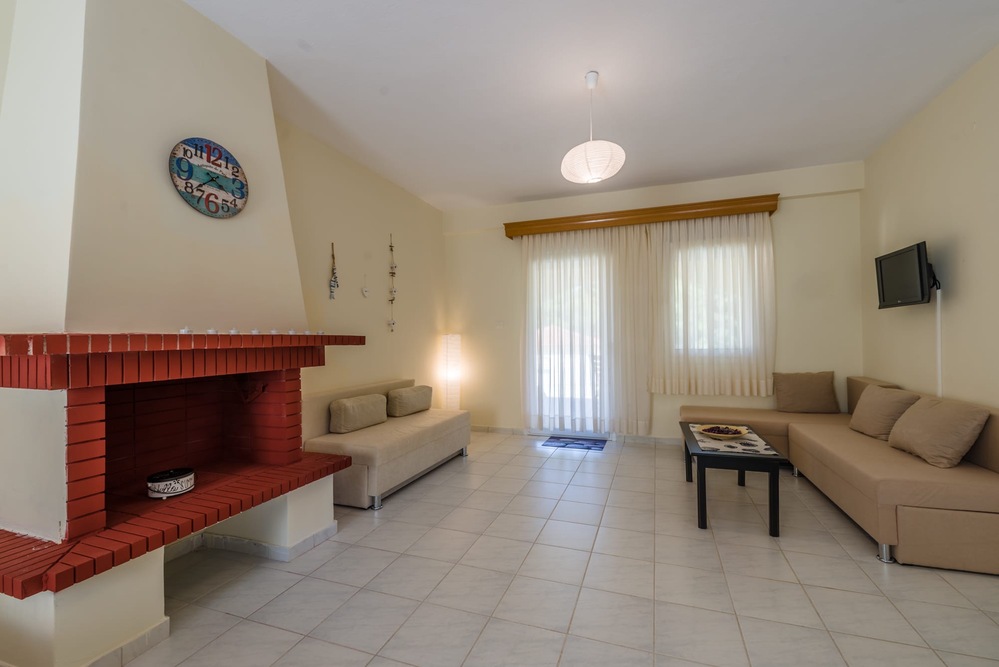 a living room with a fireplace and couches