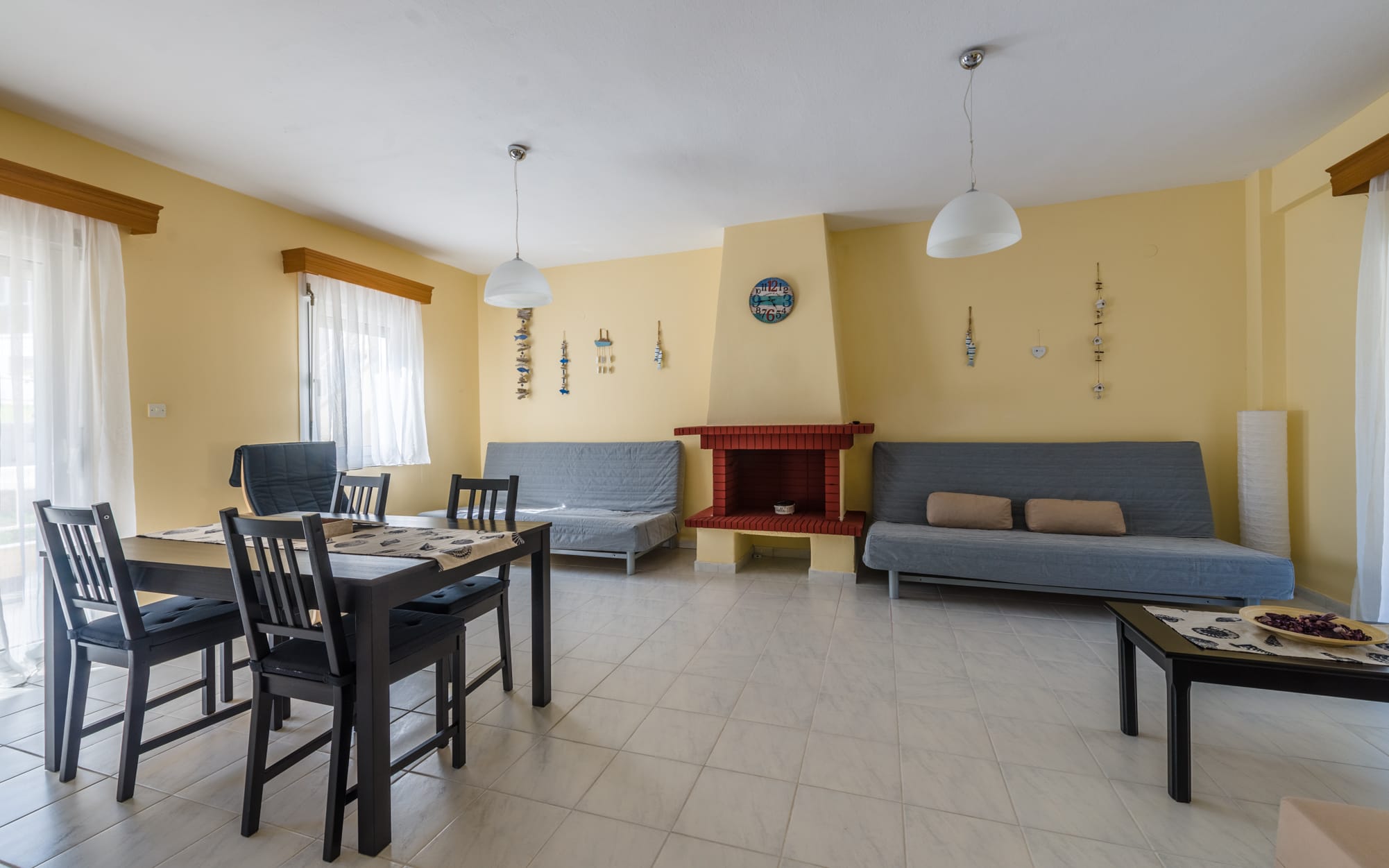a living room with a table and chairs