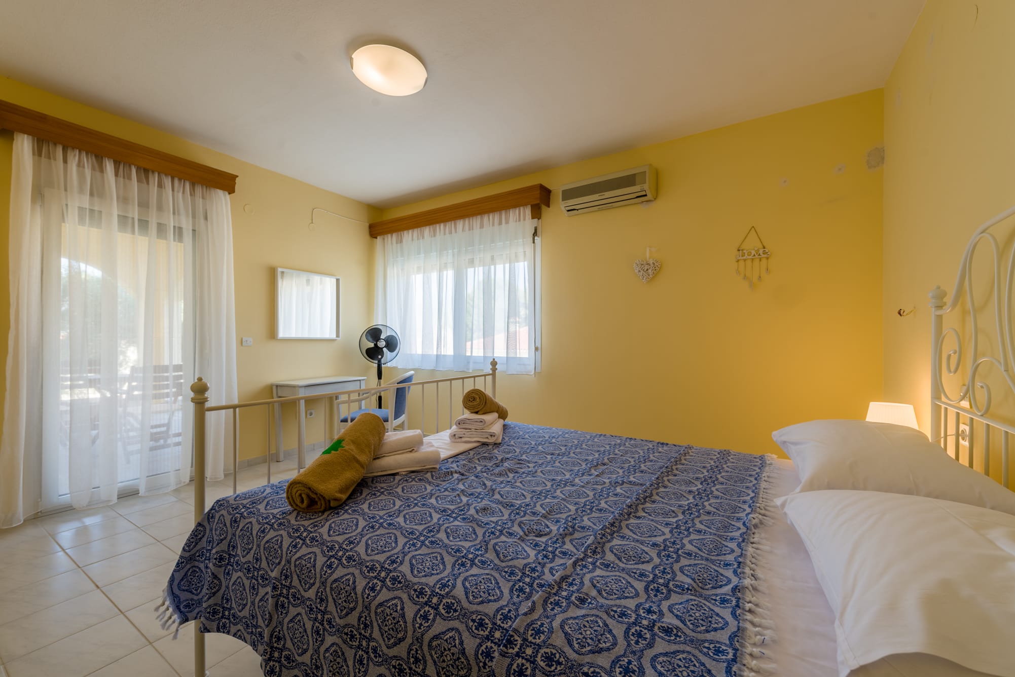 a bedroom with a bed and a desk