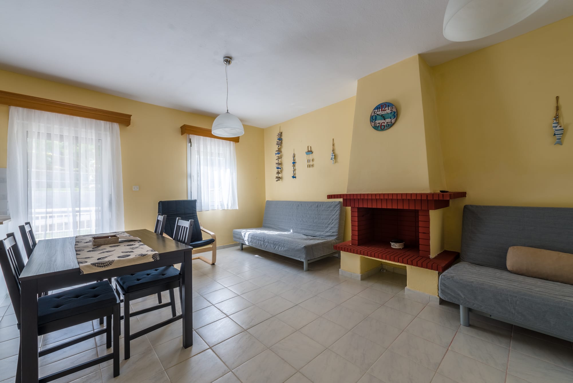 a living room with a table and chairs