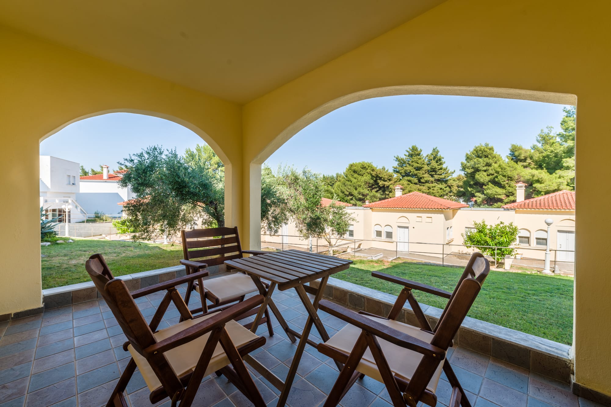 a patio with chairs and a table